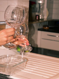 A couple of people that are holding wine glasses