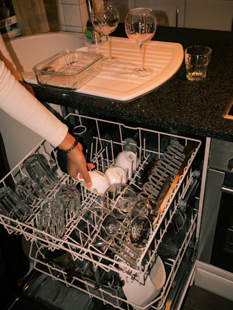 Open dishwasher with clean dishes neatly arranged