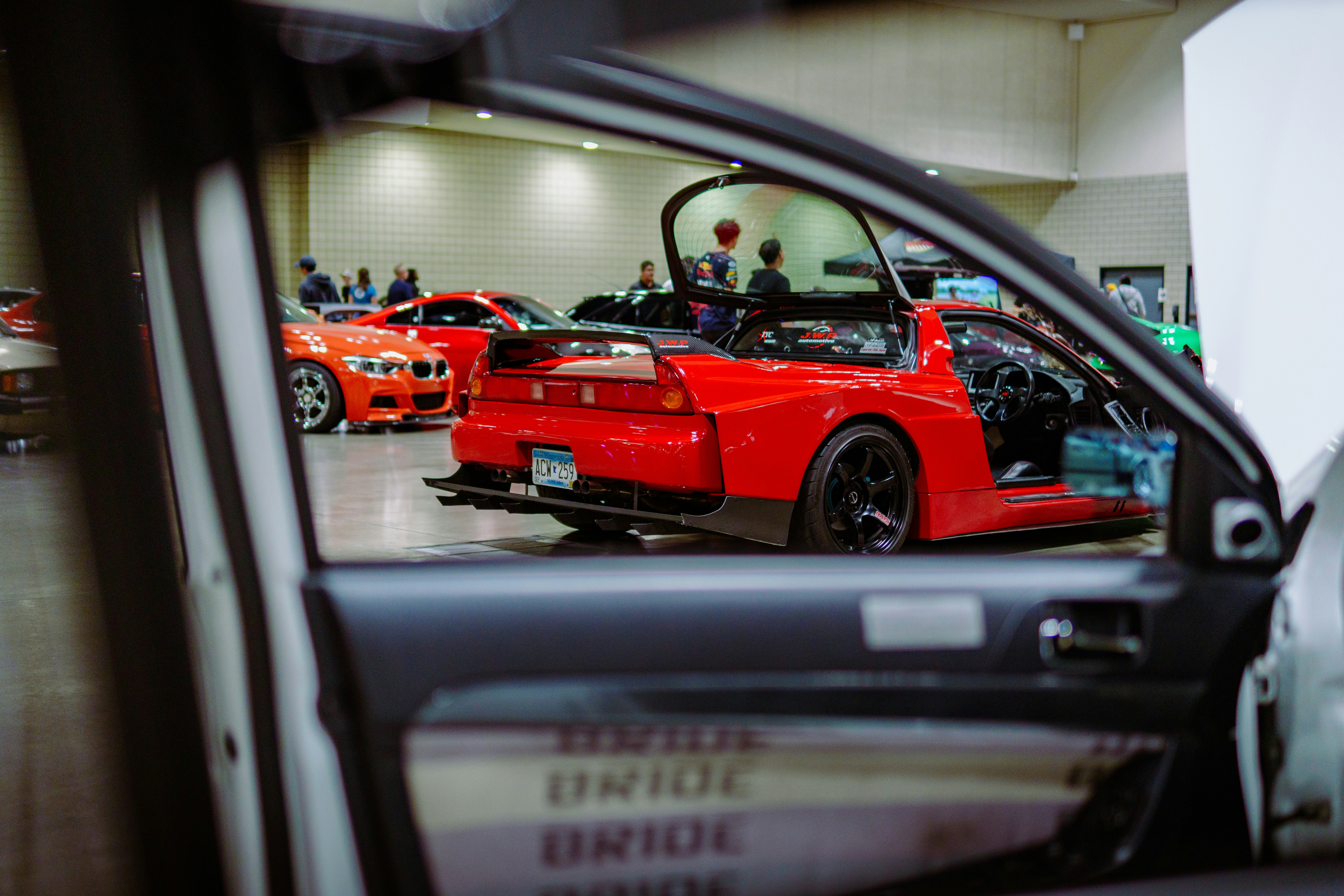 A red sports car parked in a showroom