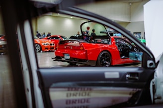A red sports car parked in a showroom