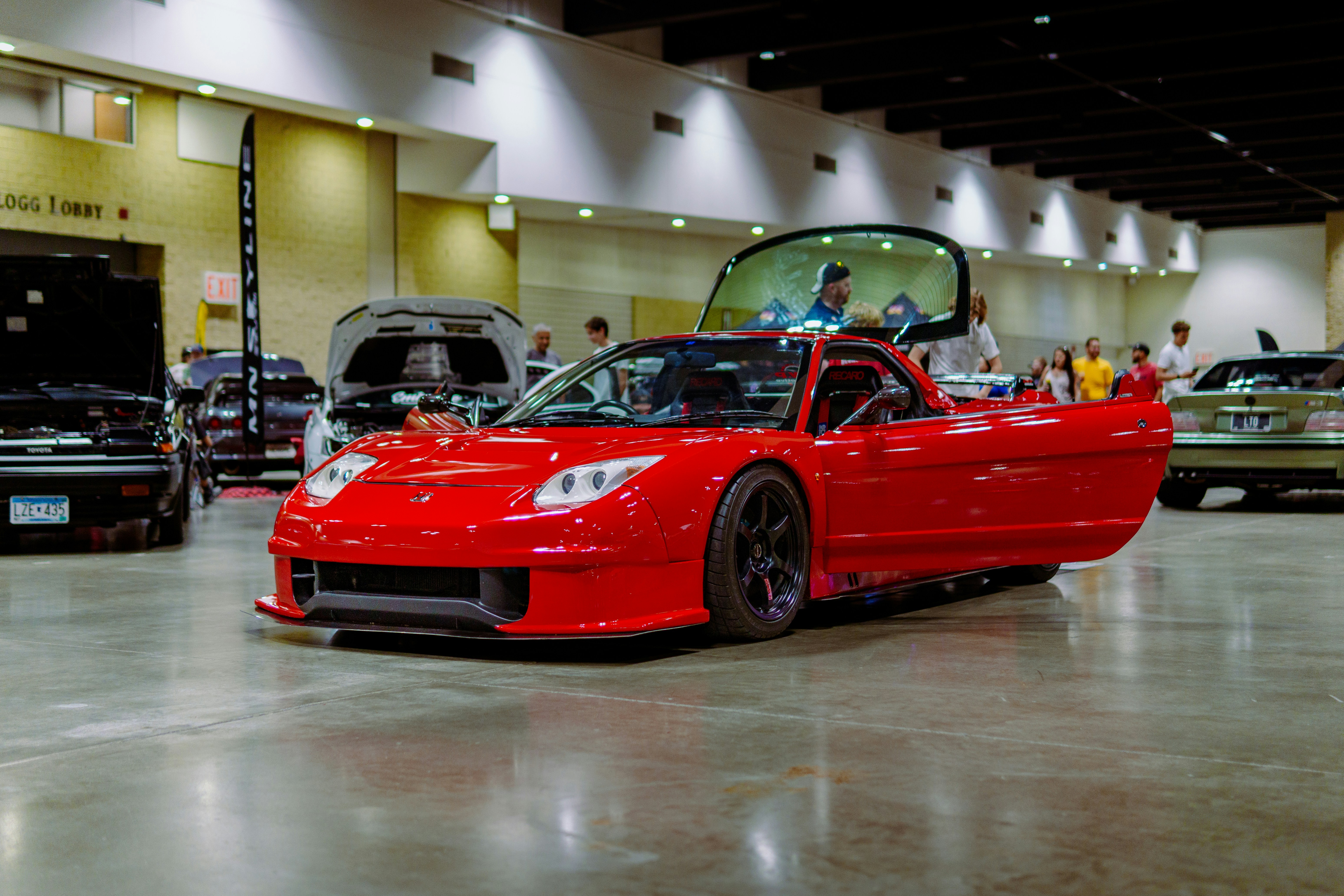 A red sports car parked in a showroom