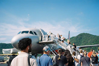 A group of people standing around a plane