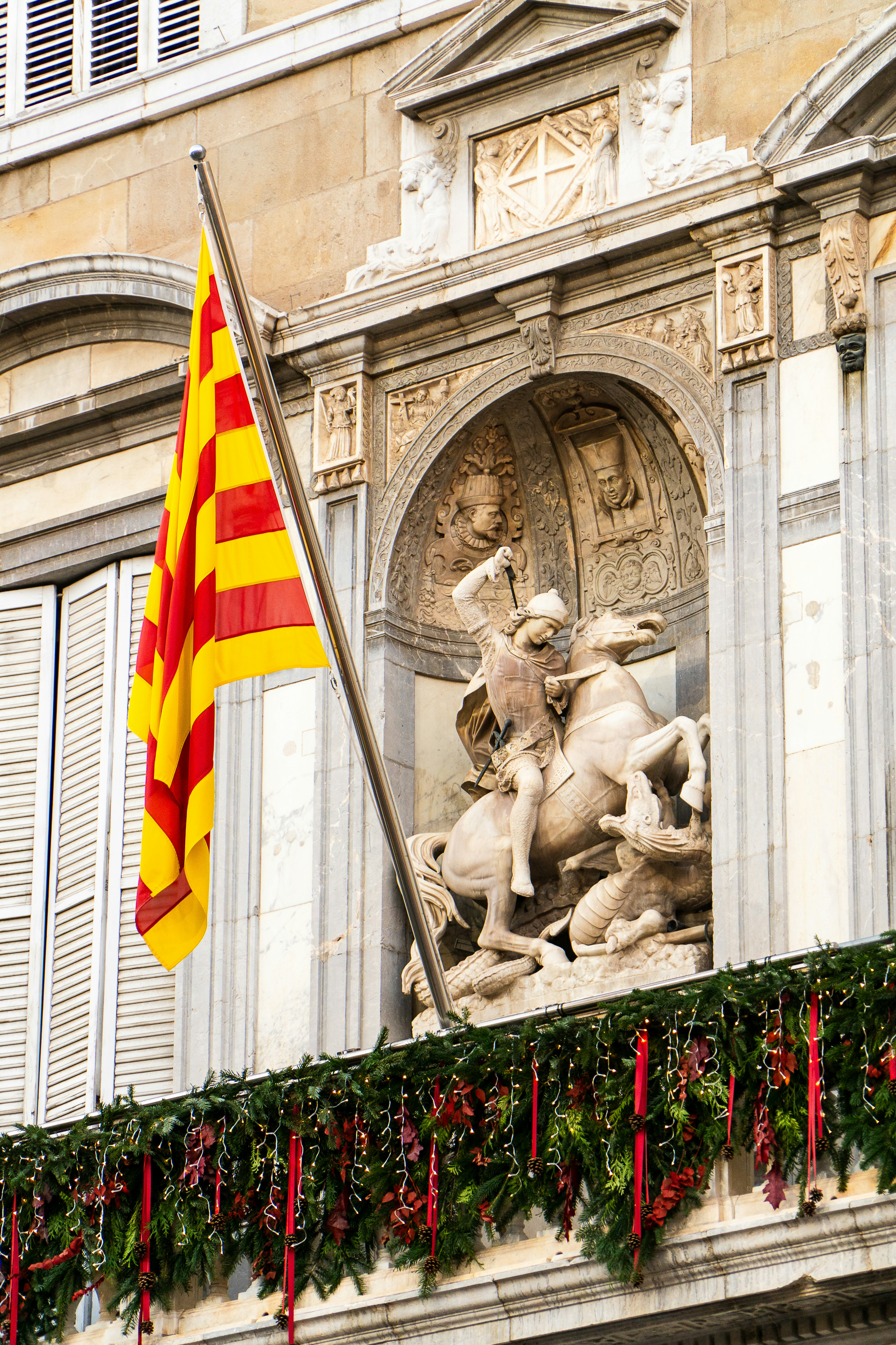 A flag and a statue on a building