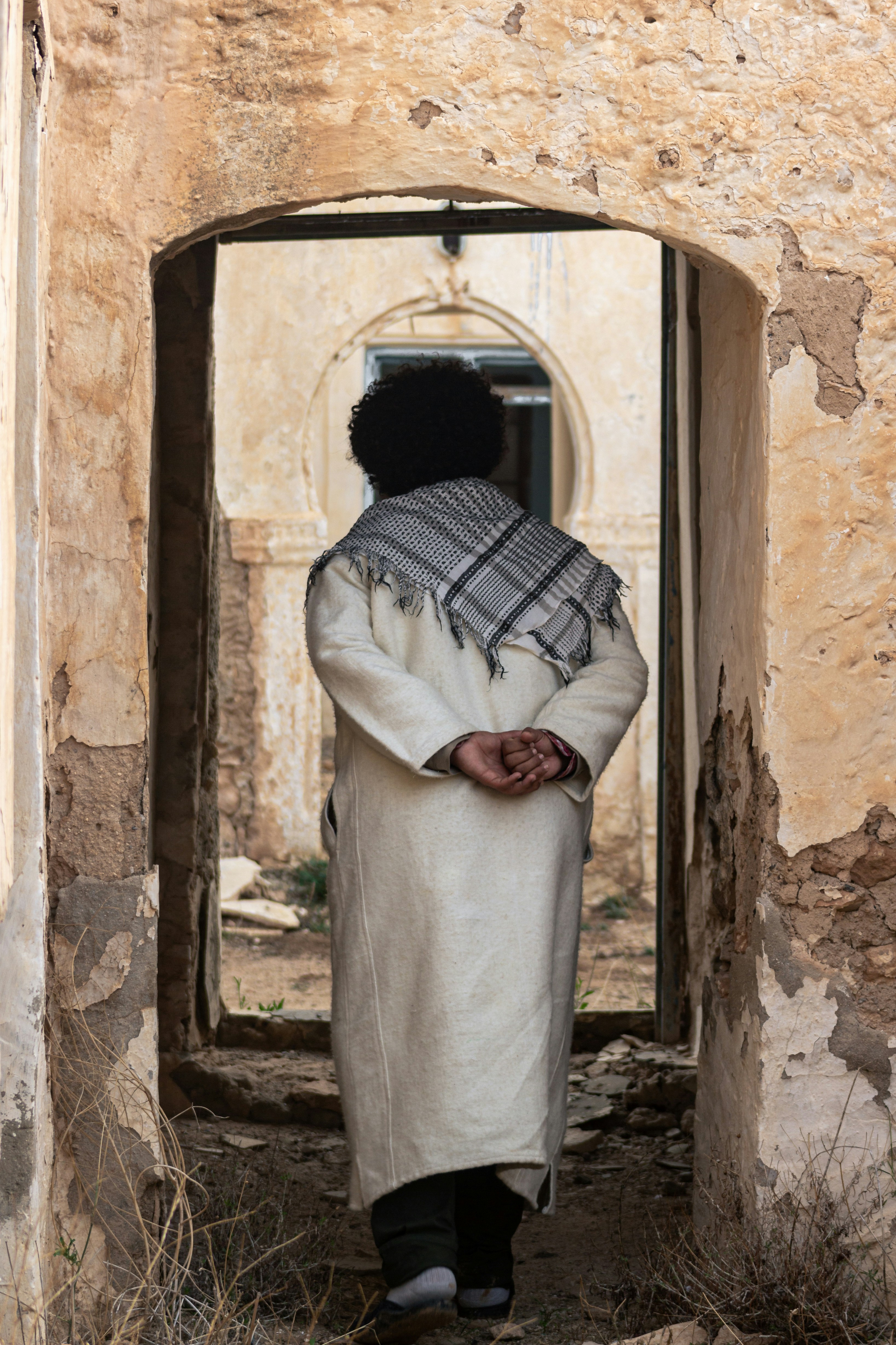 A person standing in a doorway of a building