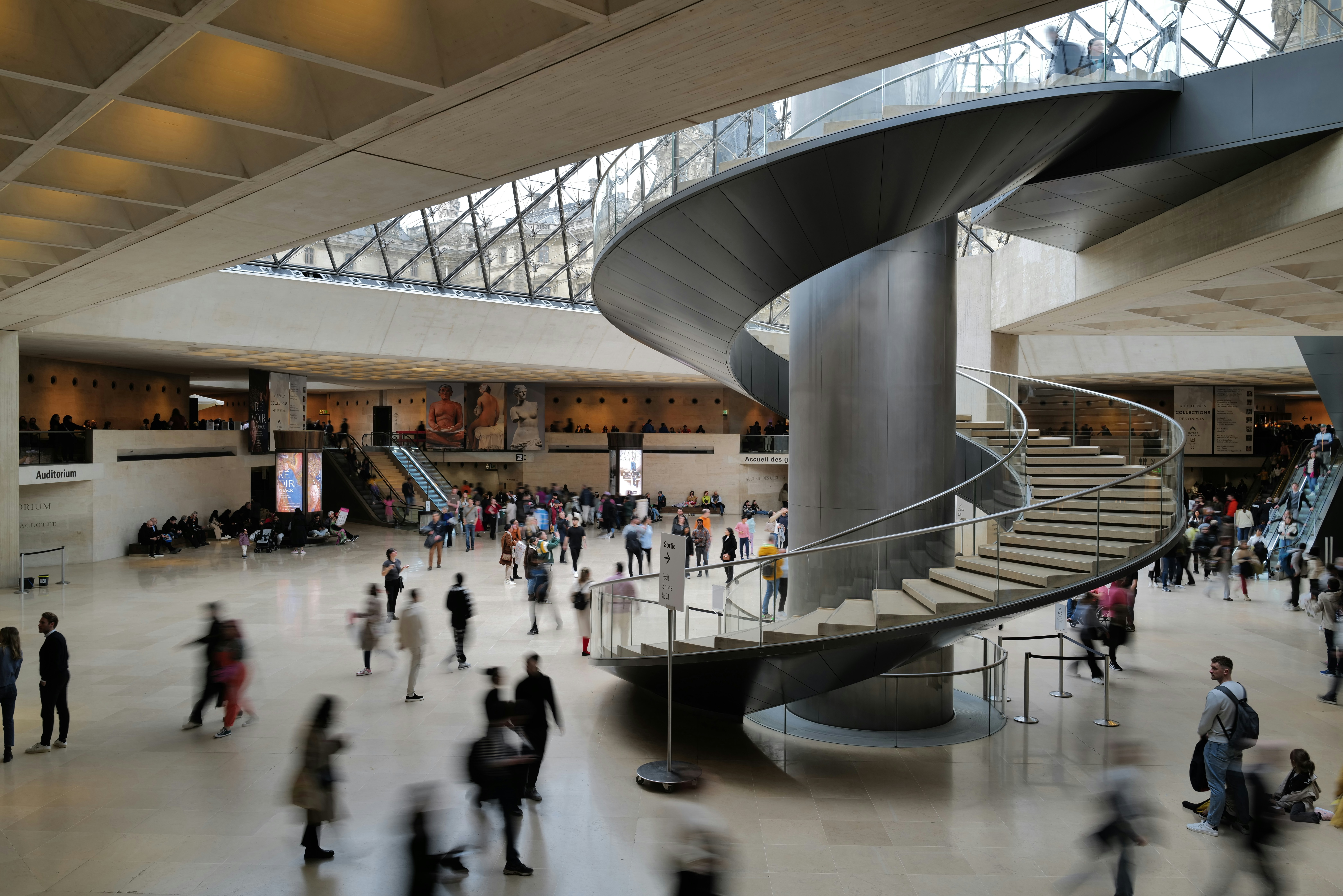 A group of people walking around a building photo – Free Building Image ...