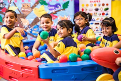 A group of children playing in a ball pit