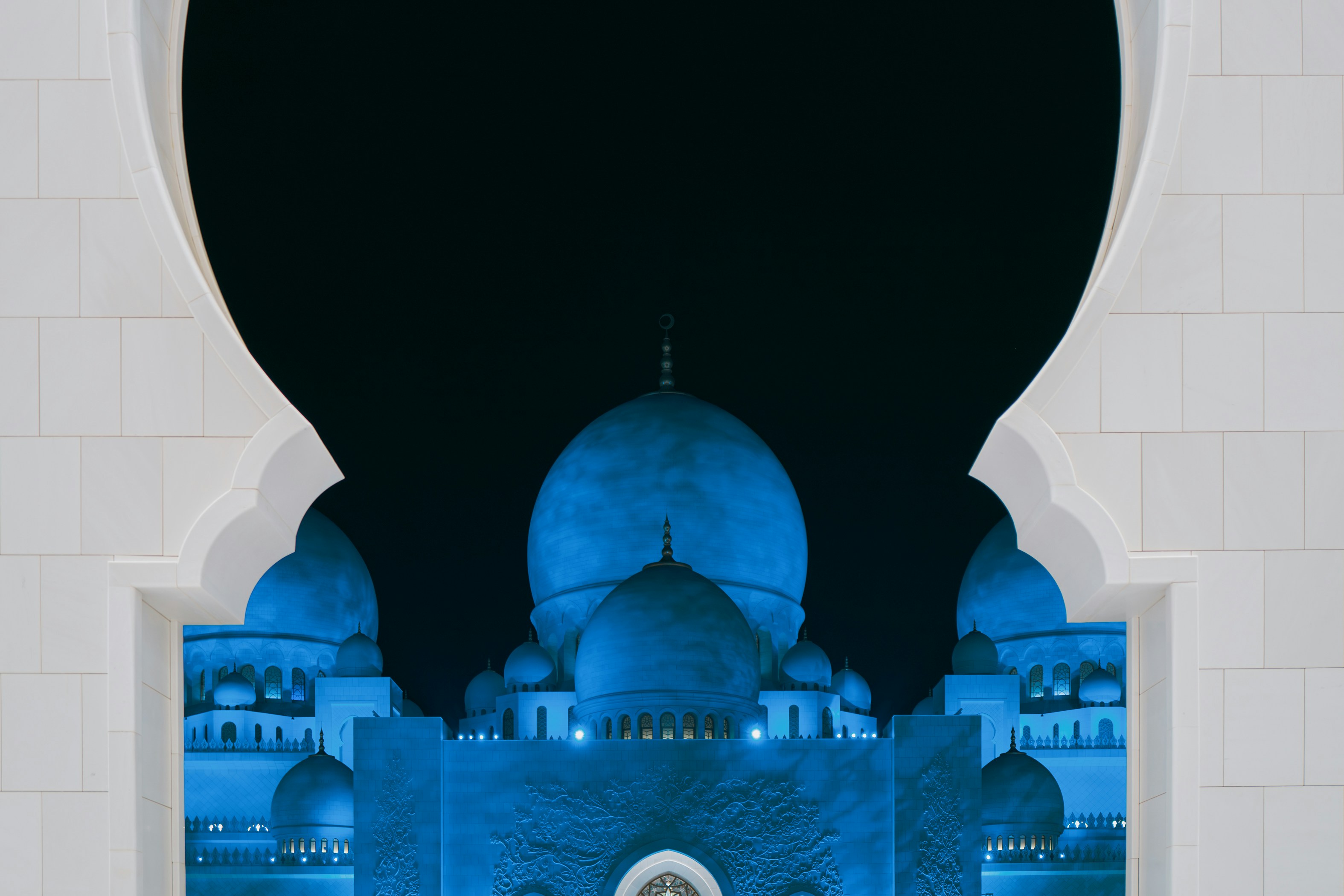 A person standing in front of a building at night