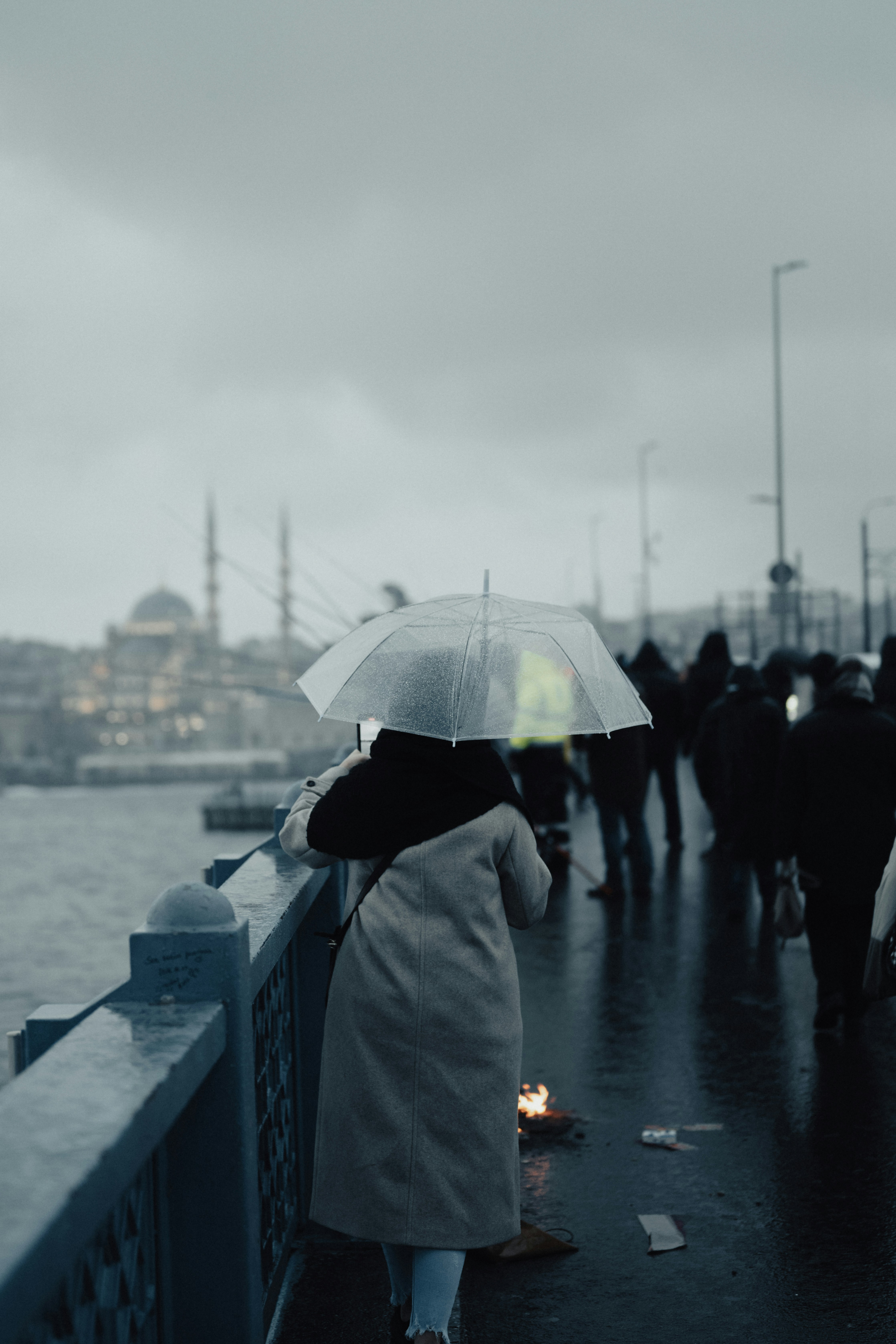 A group of people walking across a bridge