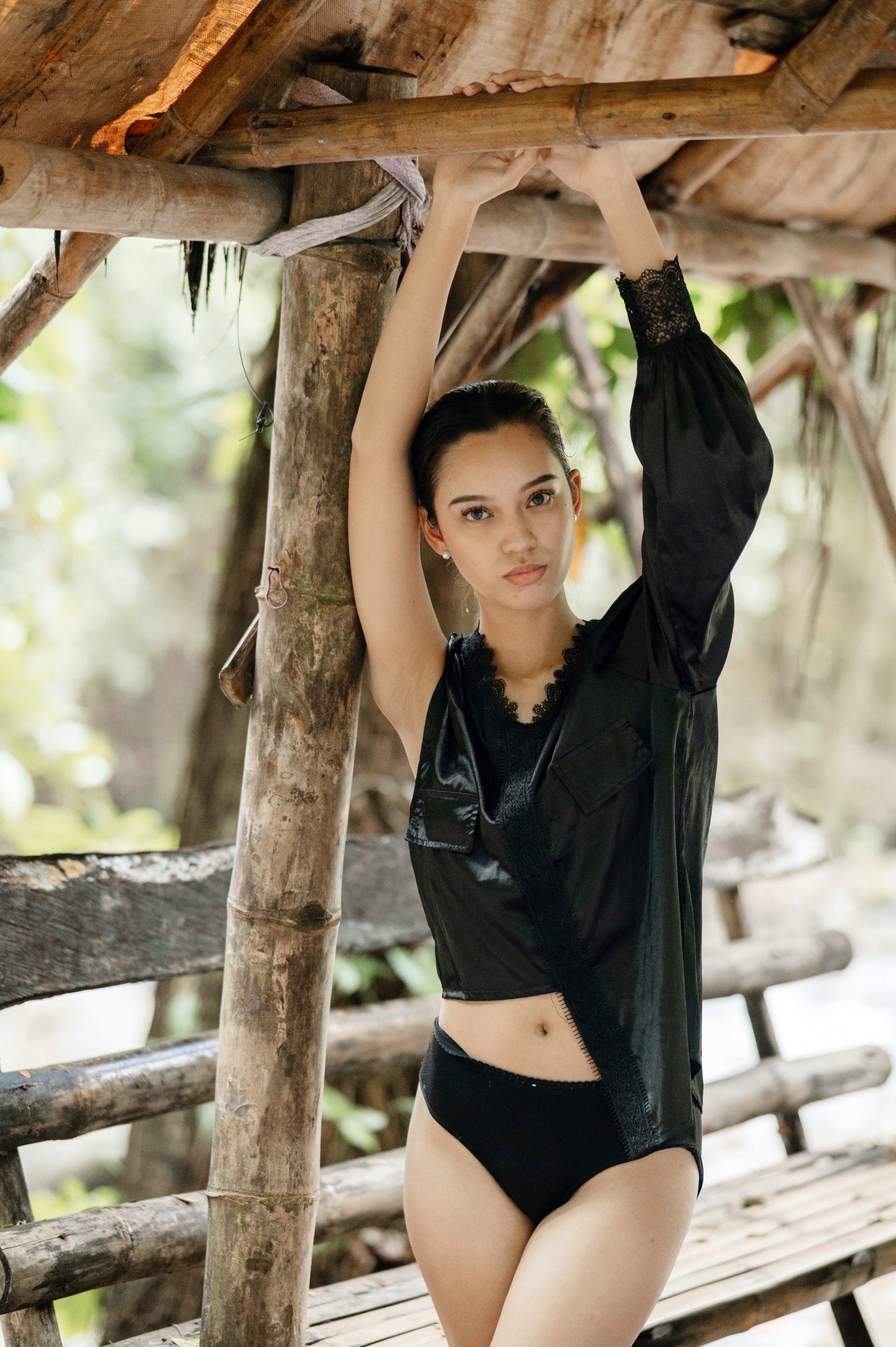 A woman in a black top and black panties