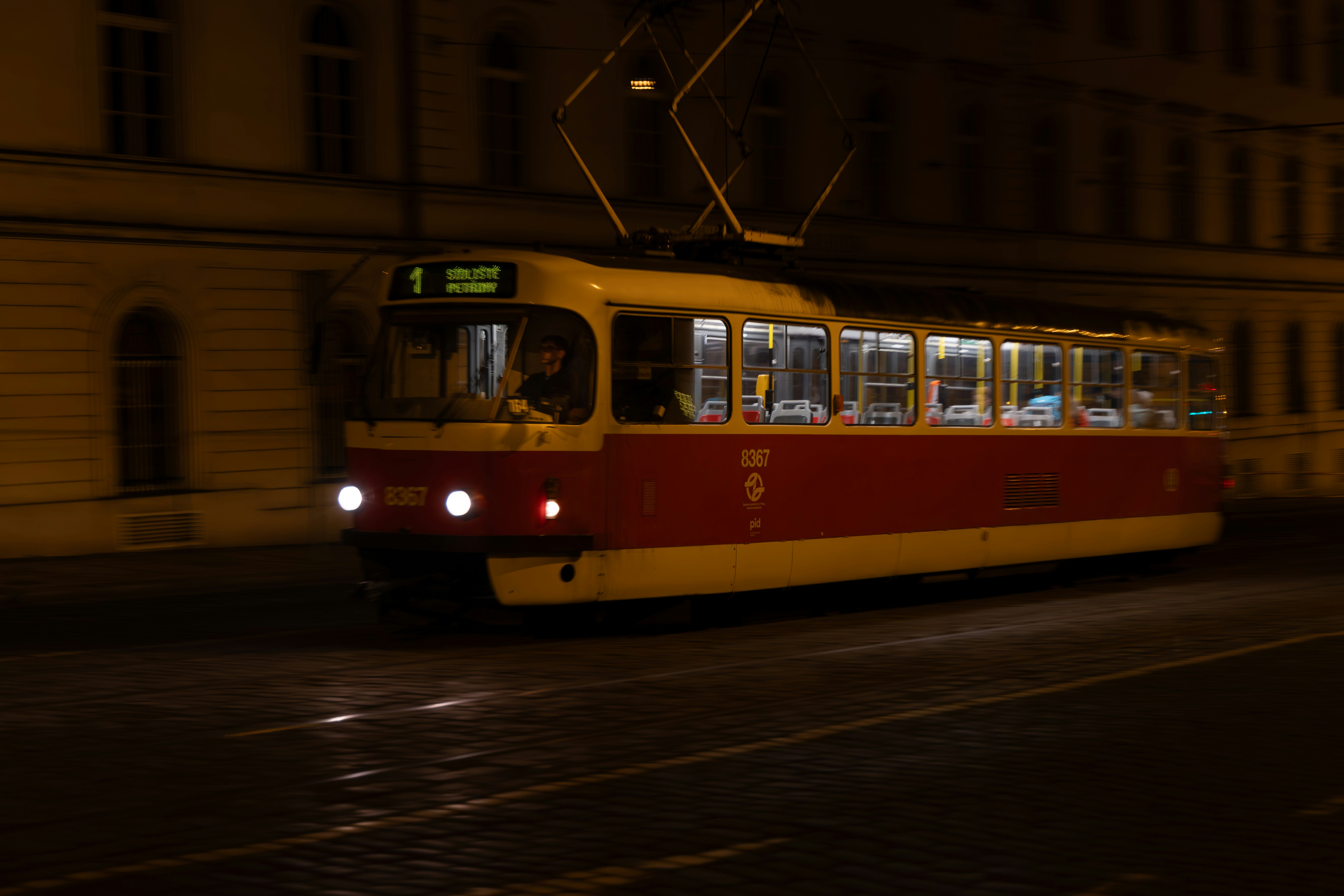 Red and yellow trolley at night