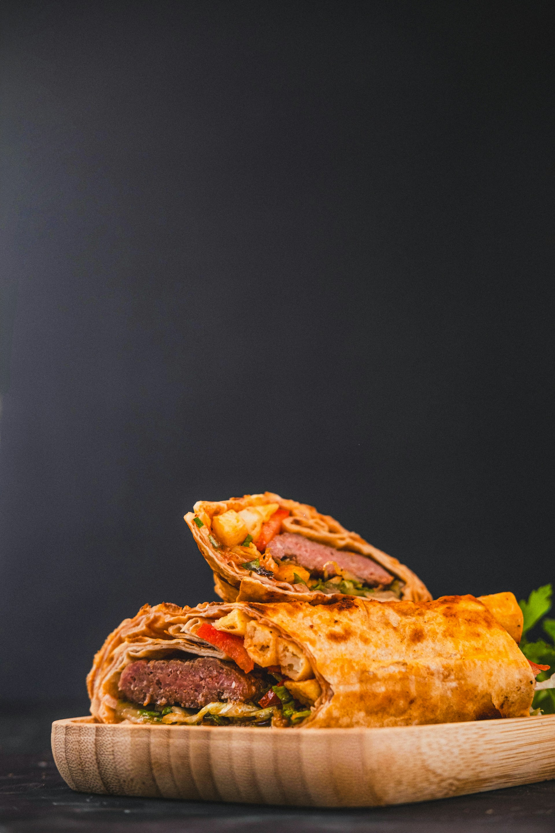 A plate of food on a table next to a glass of beer