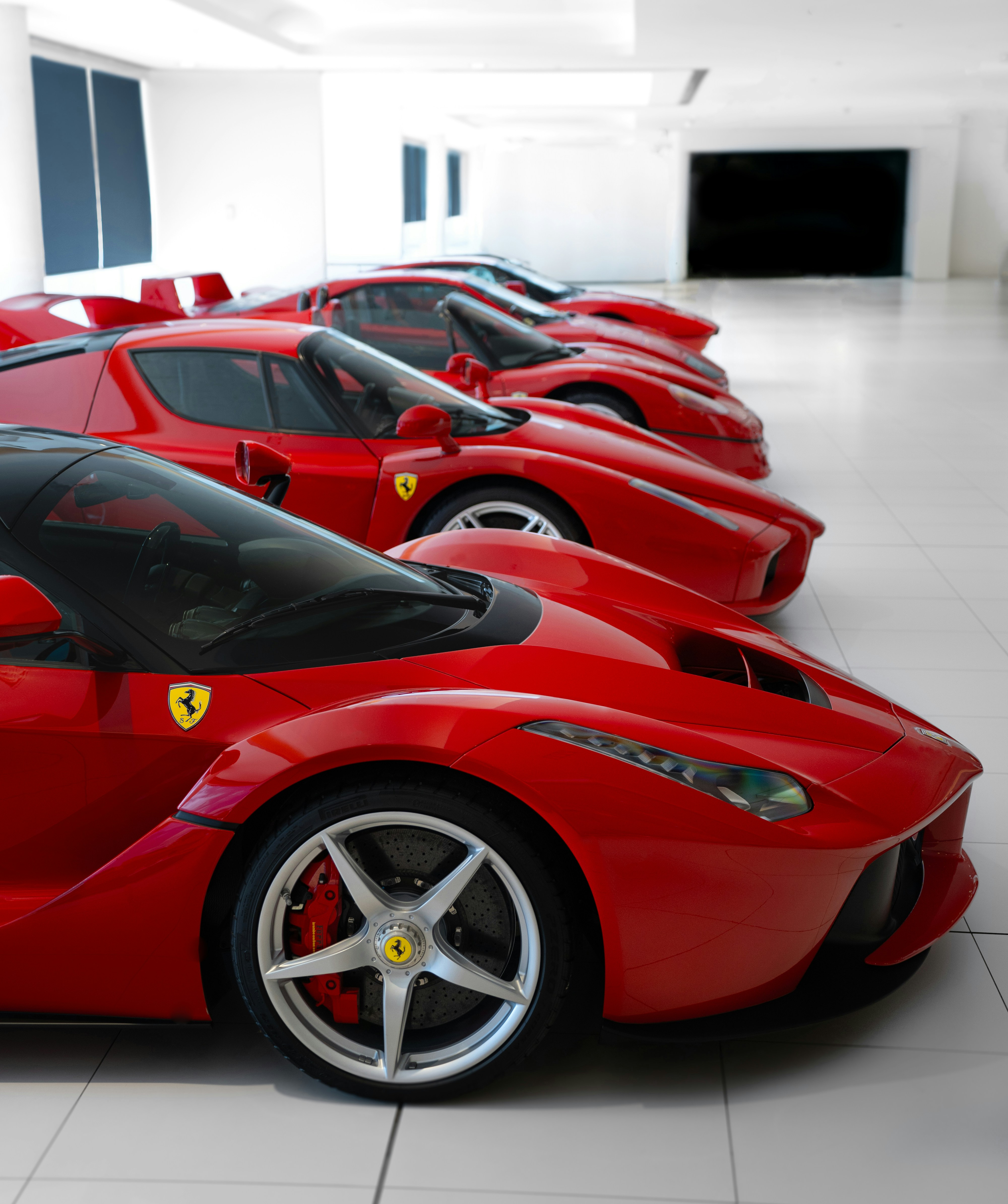 A row of red sports cars in a building