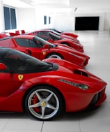 A row of red sports cars in a building