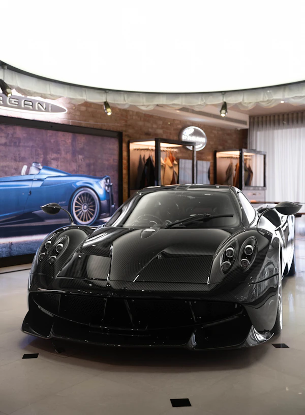 Black hypercar on display in a showroom