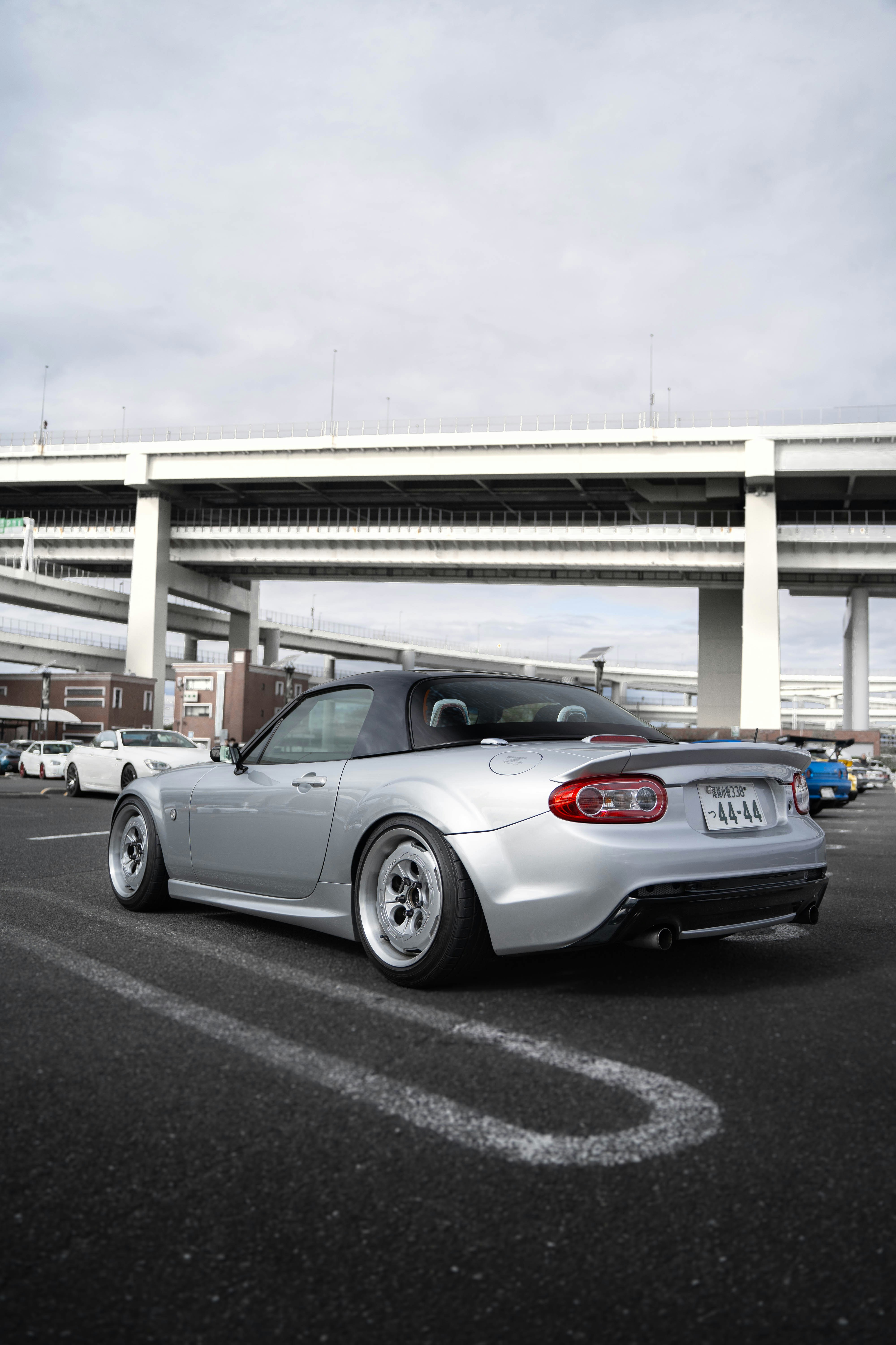 A silver sports car parked in a parking lot