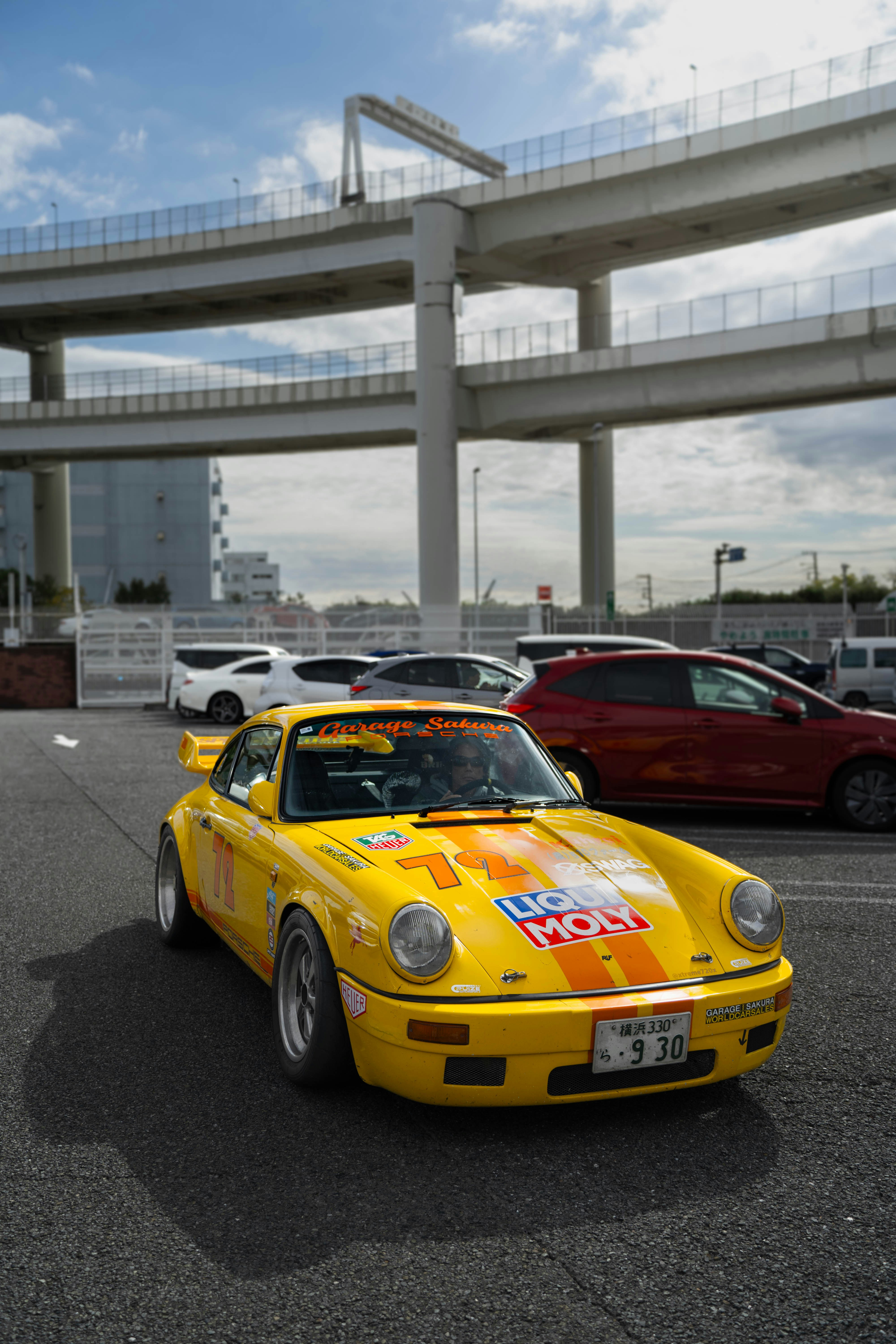 A yellow sports car parked in a parking lot