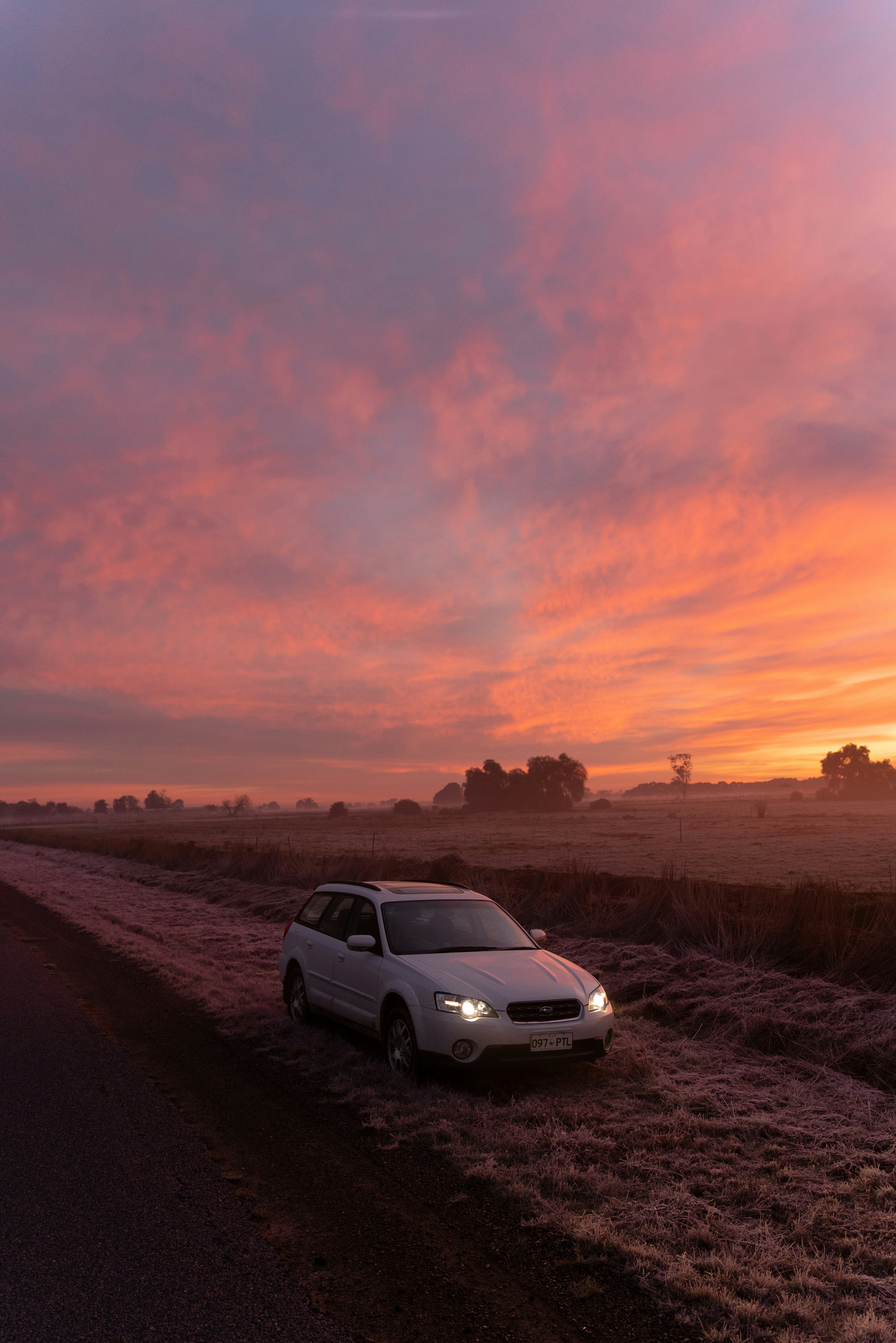 A car is parked on the side of the road photo – Free Nature Image on ...