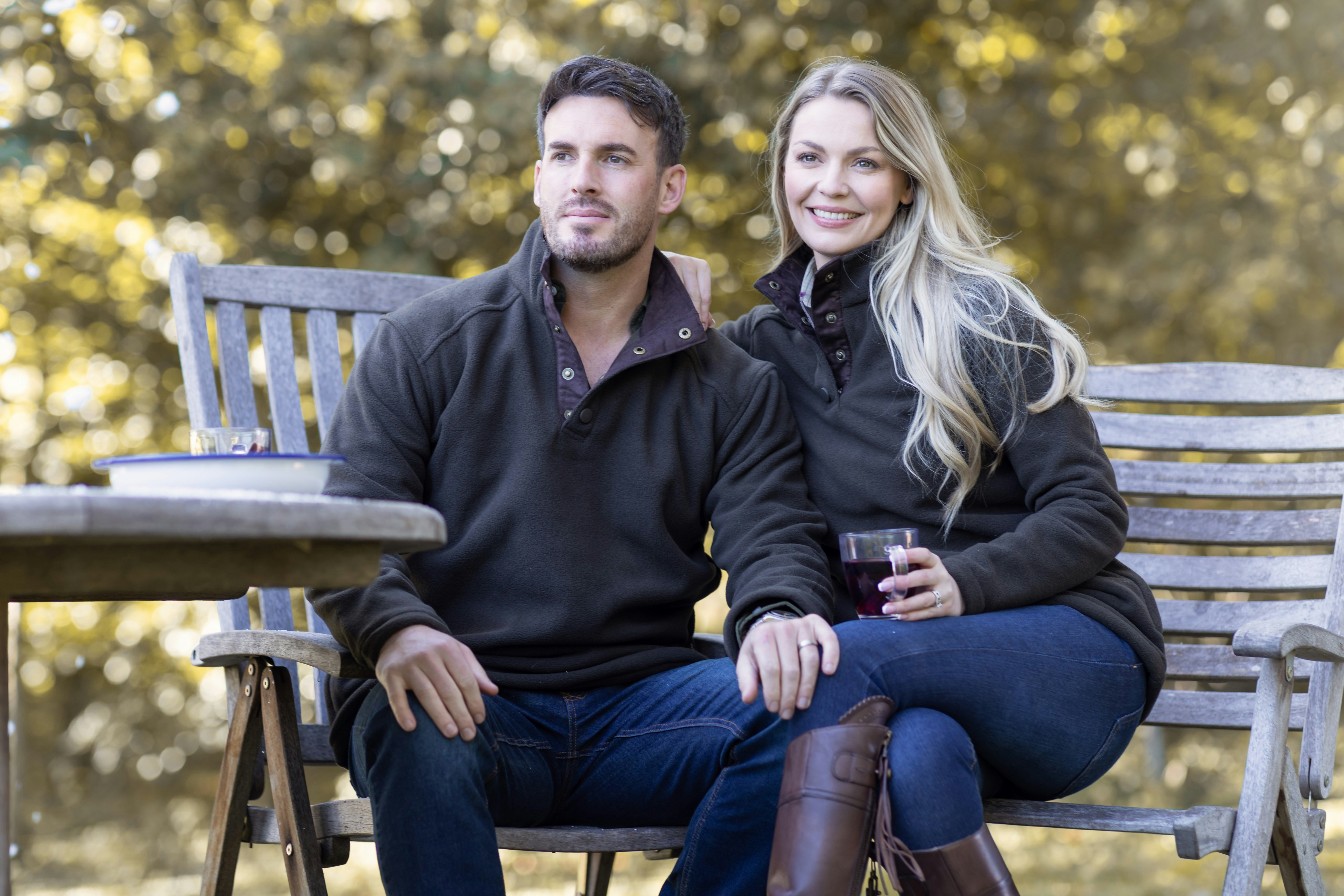 A man and a woman sitting on a bench