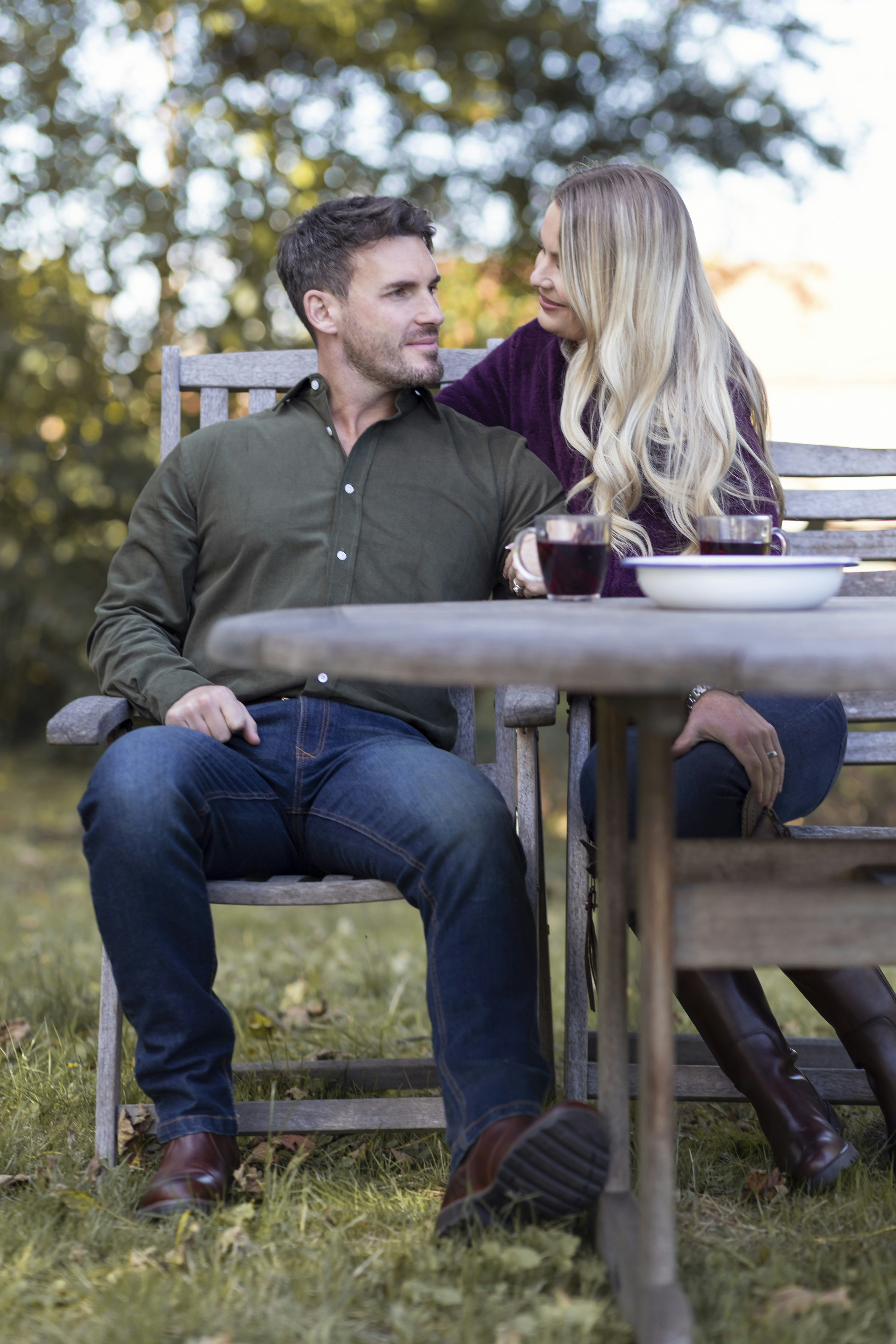 A man and a woman sitting at a picnic table