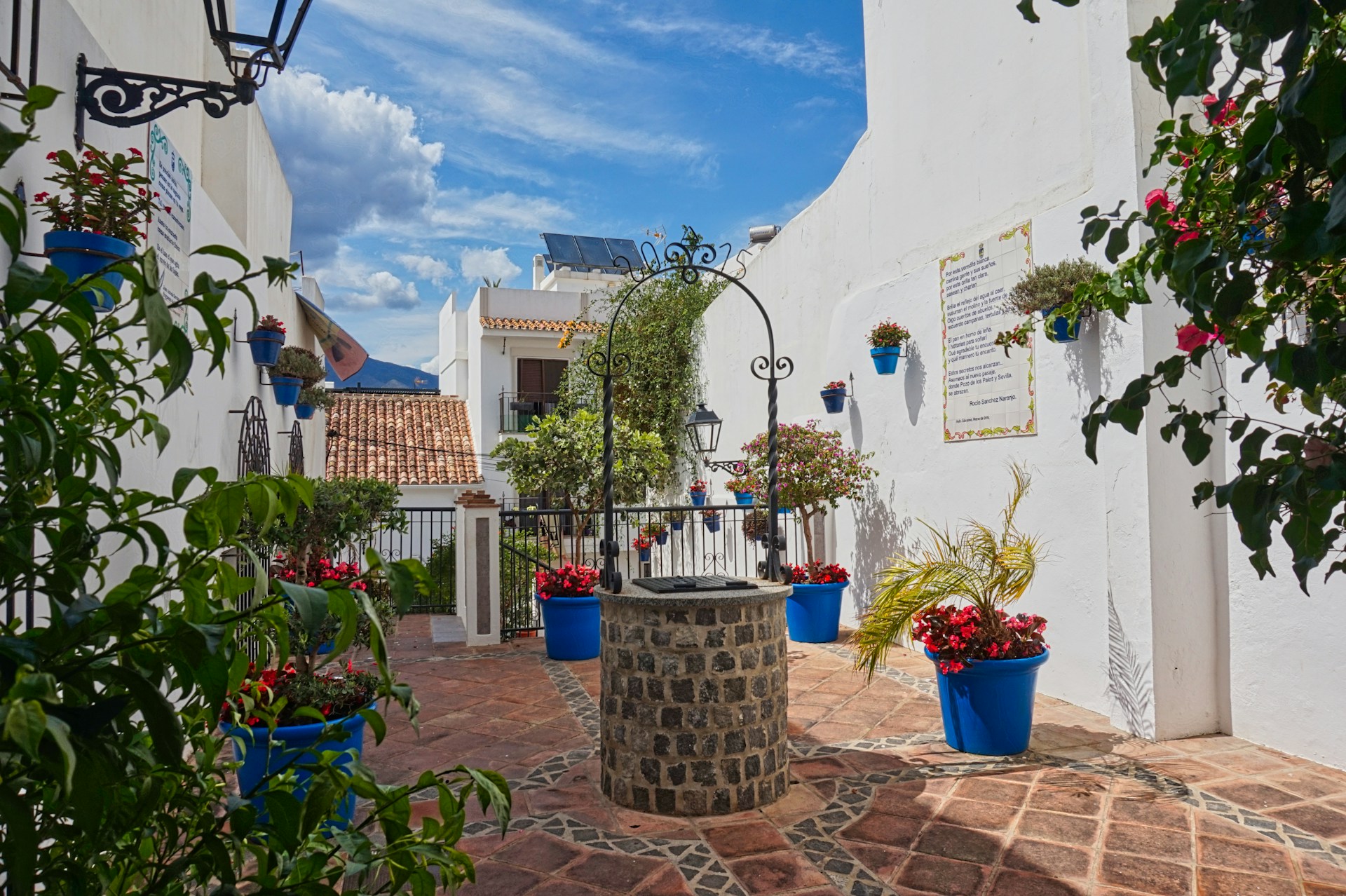 A courtyard with potted plants and a fountain