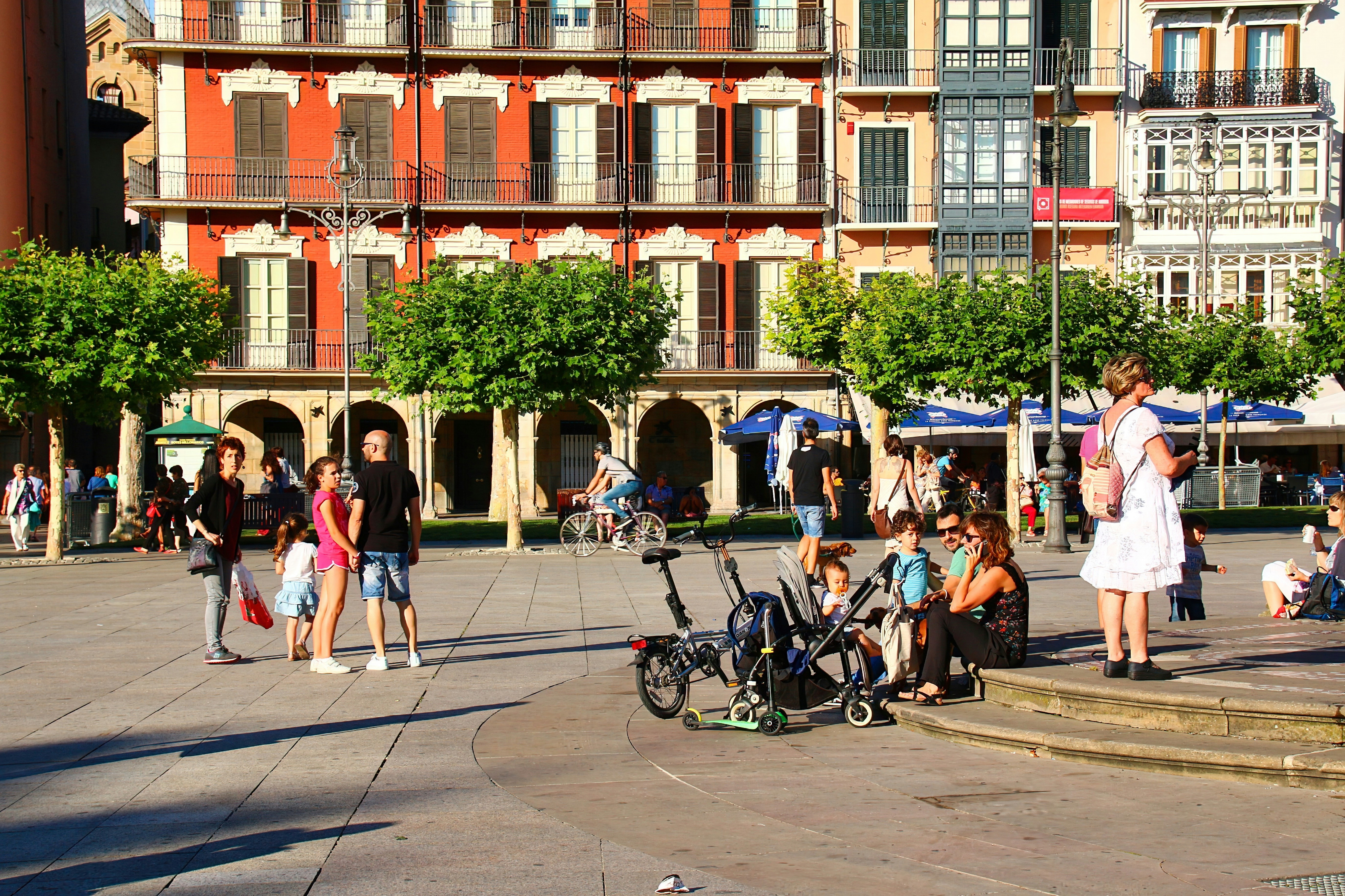 A group of people standing around in a plaza