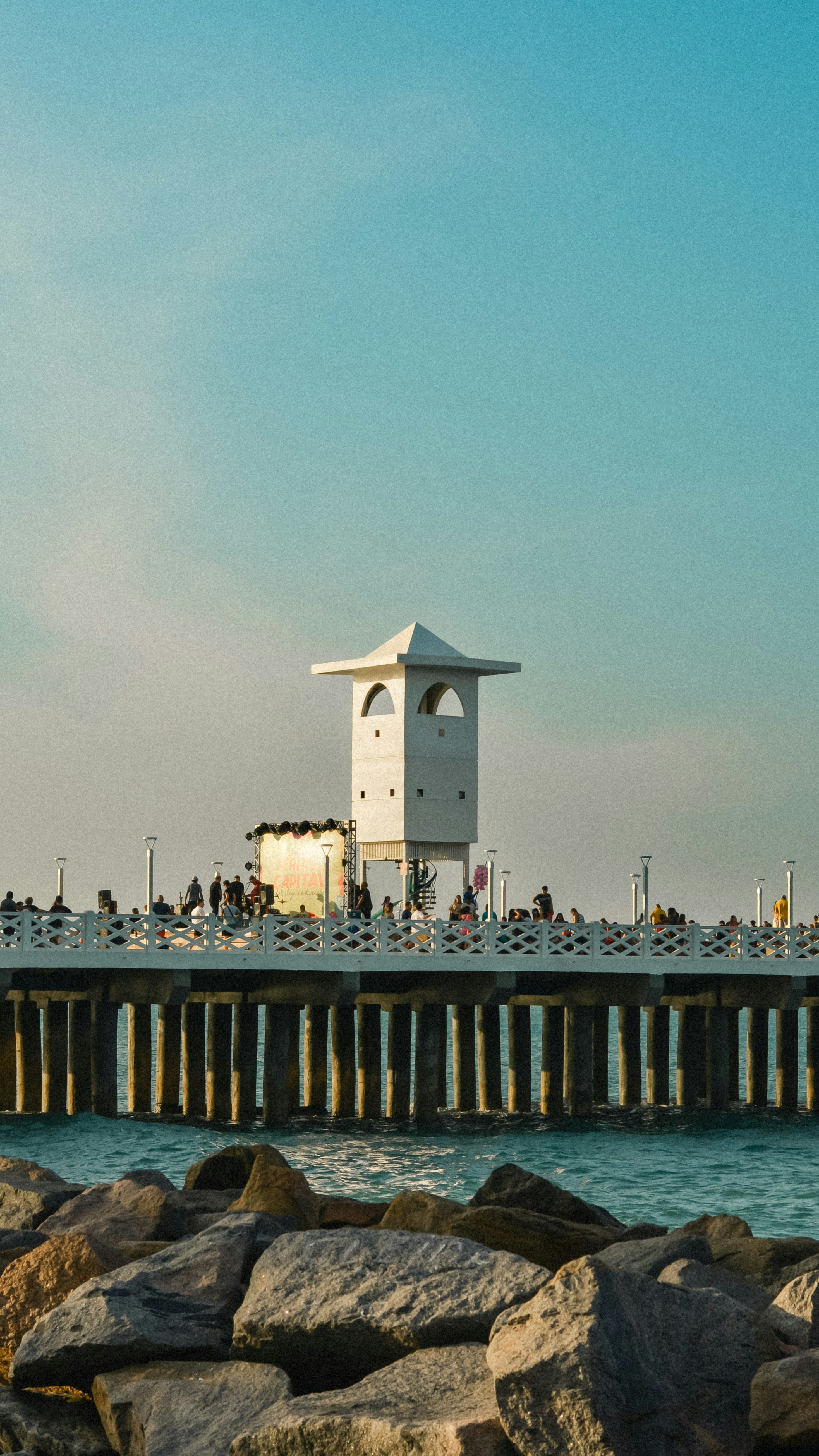 A pier with a clock tower on top of it