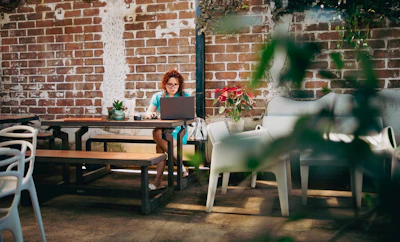 A woman sitting at a table with a laptop