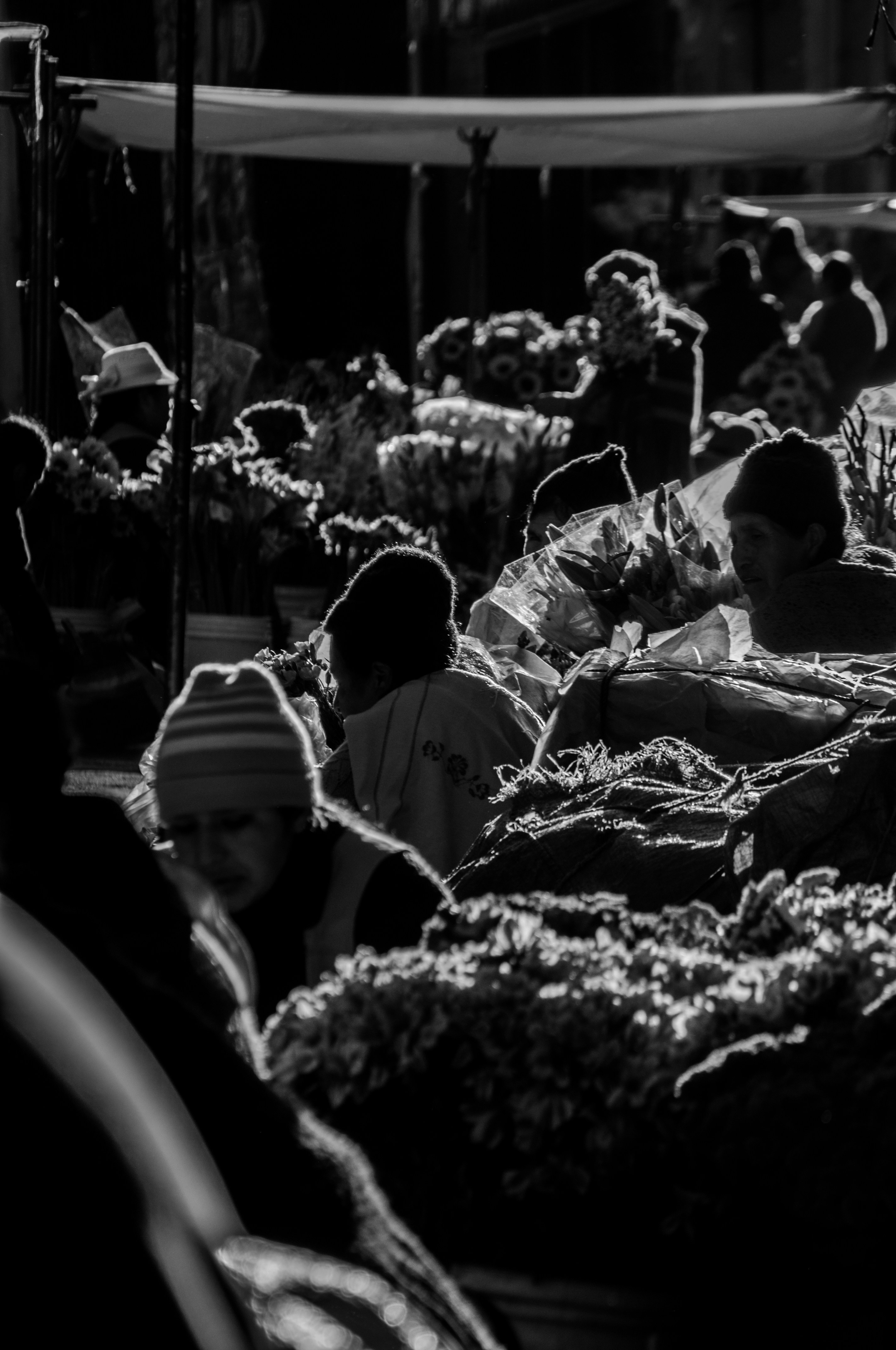 A black and white photo of people in a market