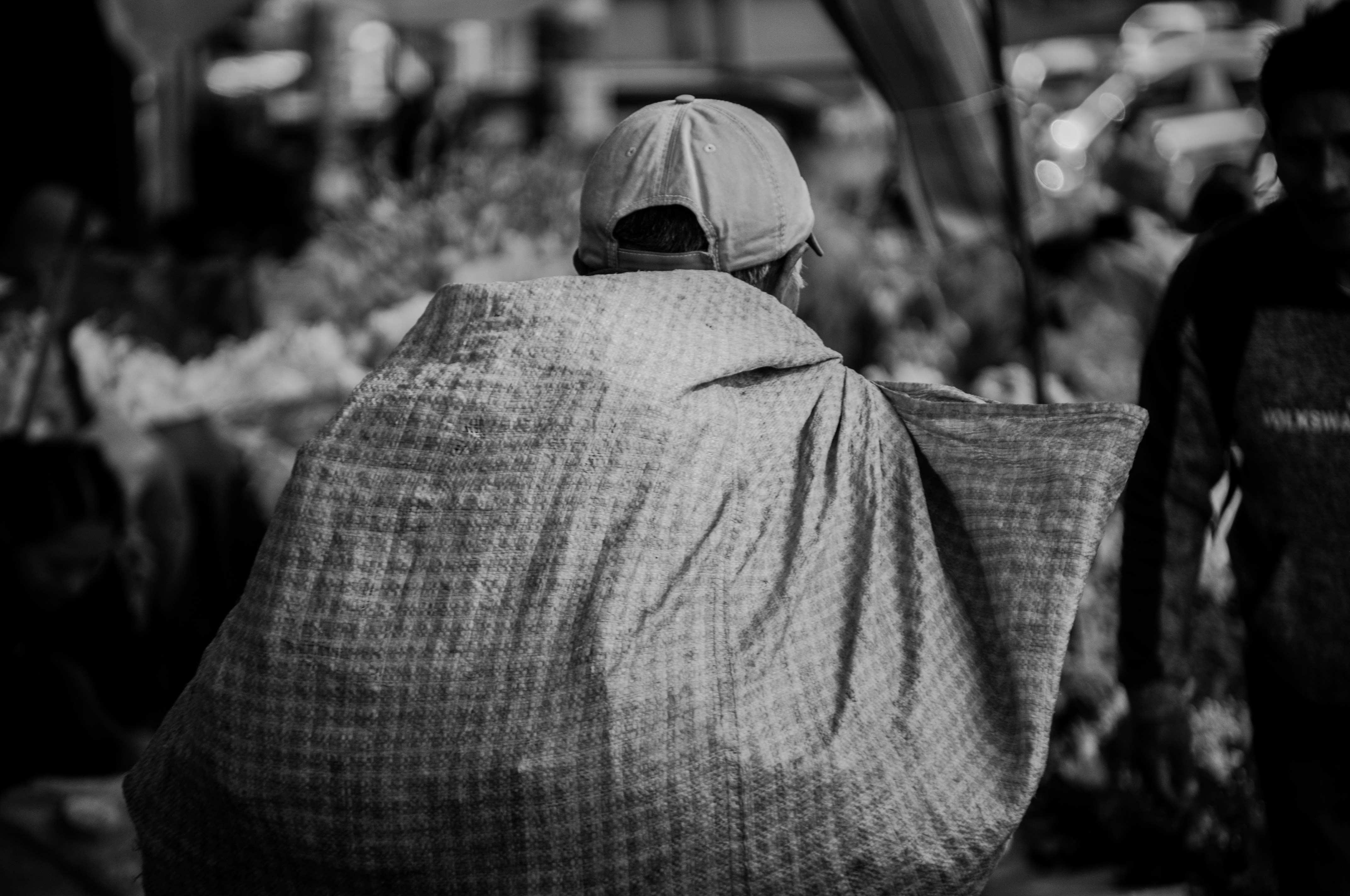 A man walking down a street next to a crowd of people