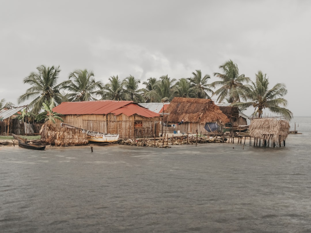 A house on a small island in the middle of a body of water