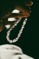 A person holding a rosary in their hand
