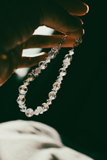 A person holding a rosary in their hand