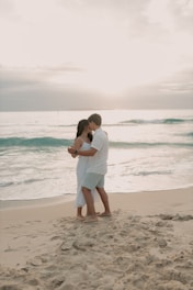 A man and woman embracing on the beach
