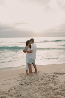 A man and woman embracing on the beach