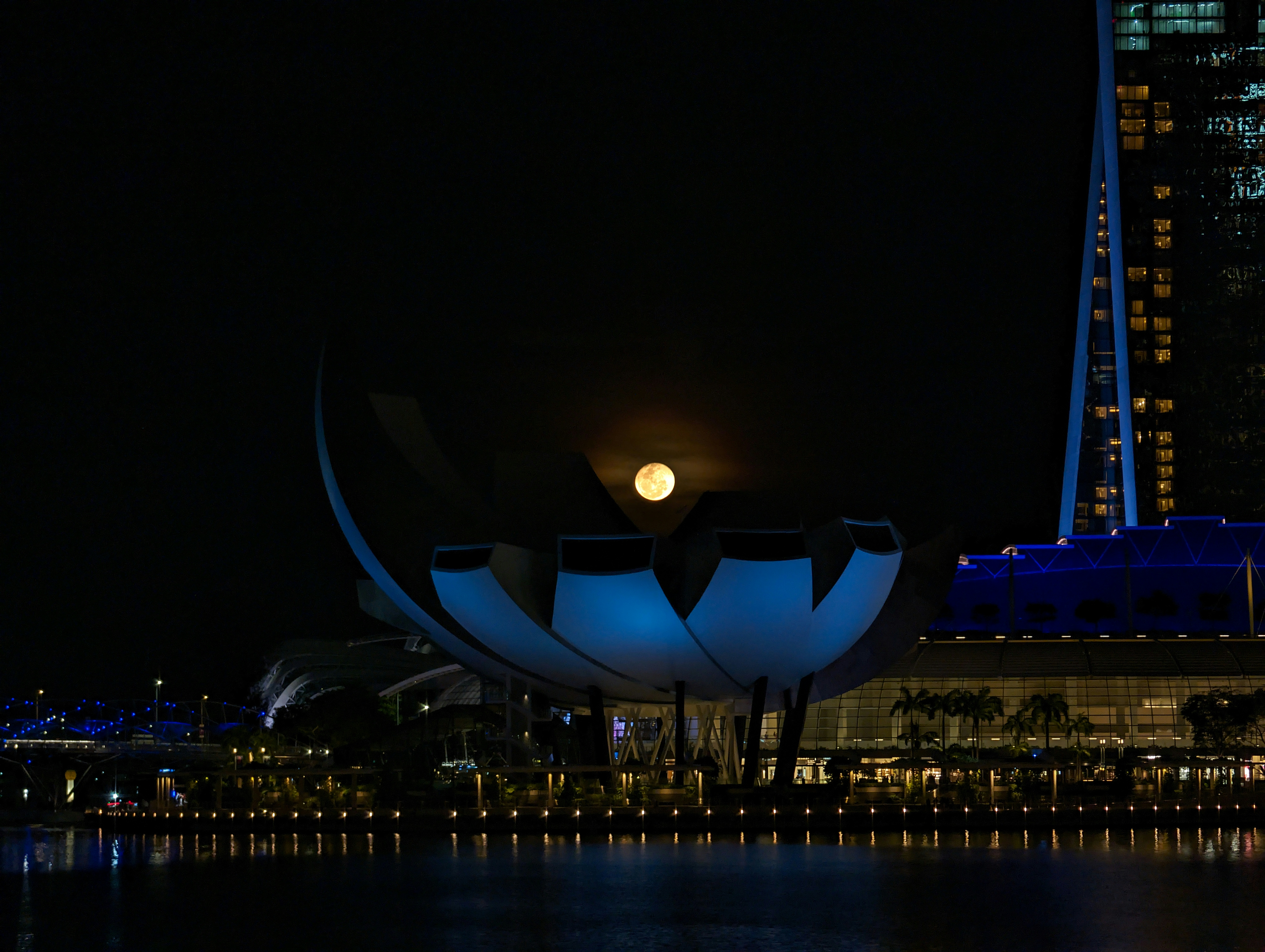 A city skyline at night with a building lit up