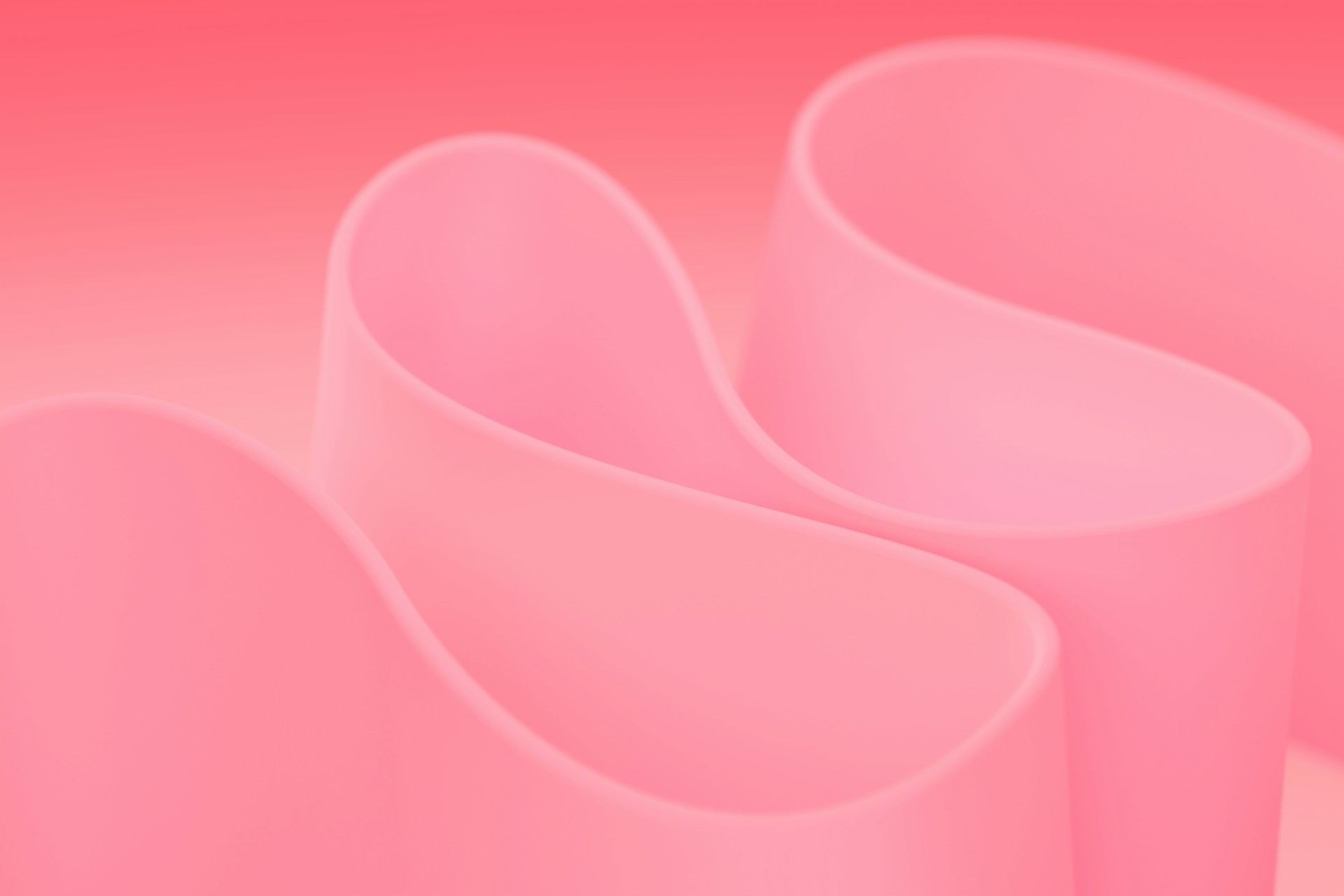 Three pink vases sitting next to each other on a pink background