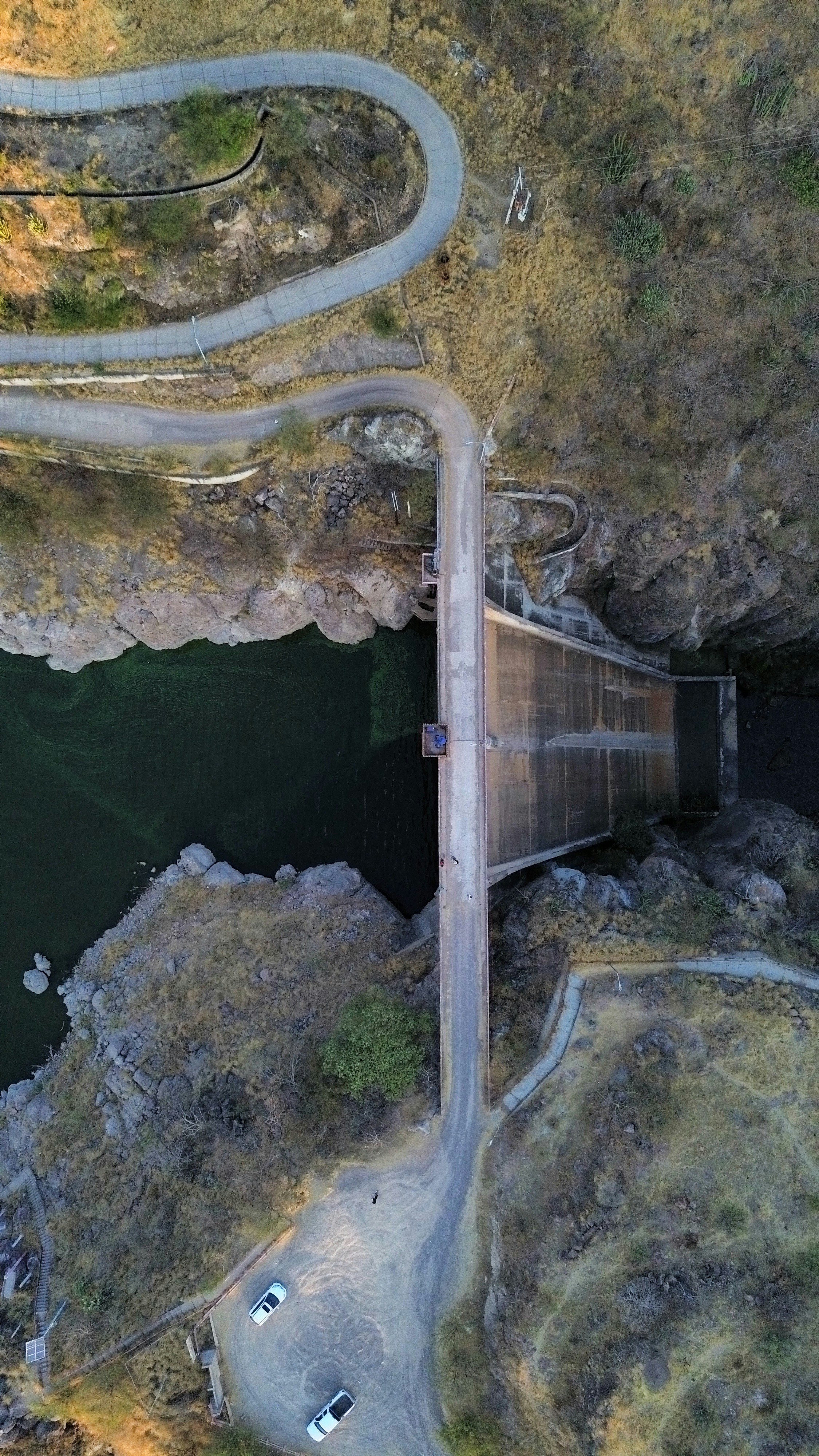 An aerial view of a road and a dam