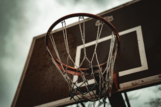 A basketball hoop with a cloudy sky in the background