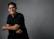 A man in a black shirt is posing for a picture