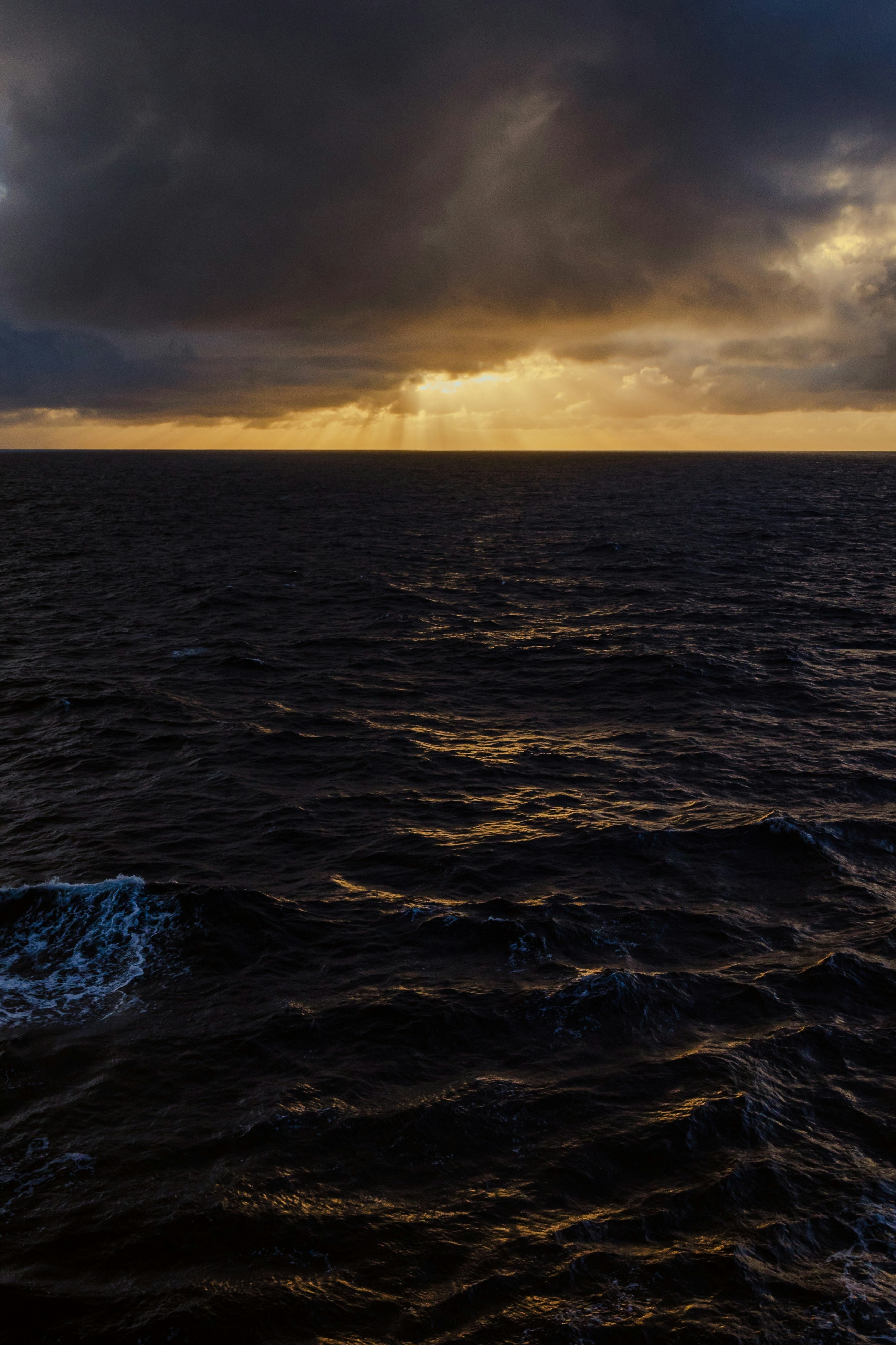 A large body of water under a cloudy sky