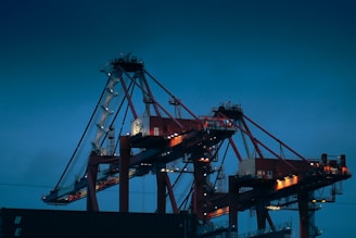 A large cargo ship is docked at night