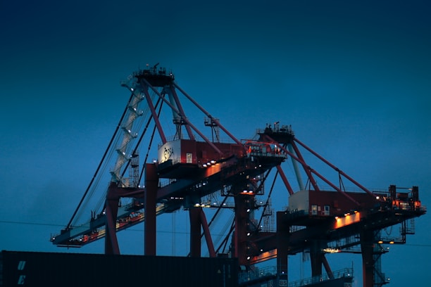 A large cargo ship is docked at night