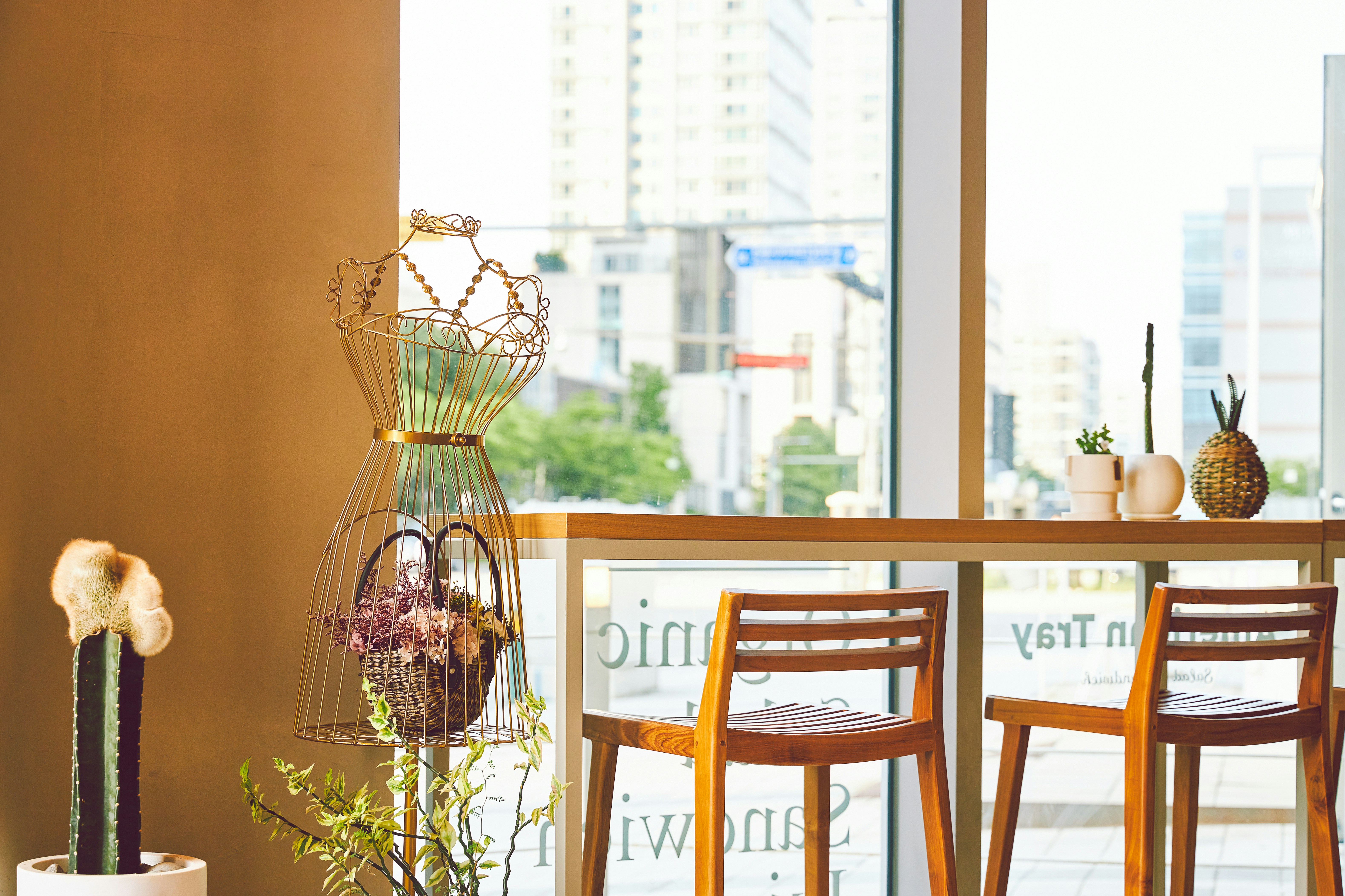 A dining room table with chairs and a vase with flowers
