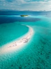 A group of people on a small island in the middle of the ocean