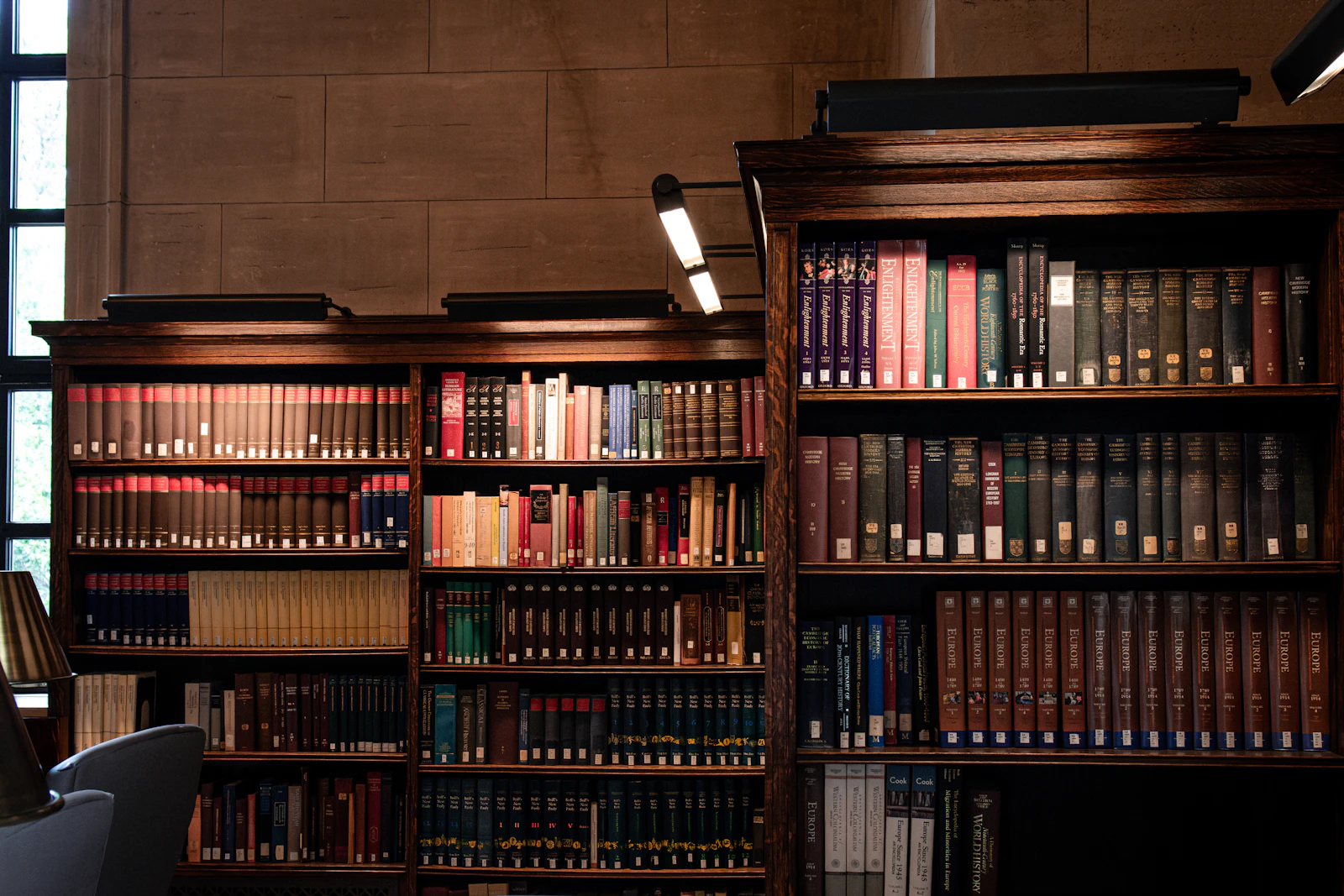 Rows of bound volumes on wooden shelves inside a university law library