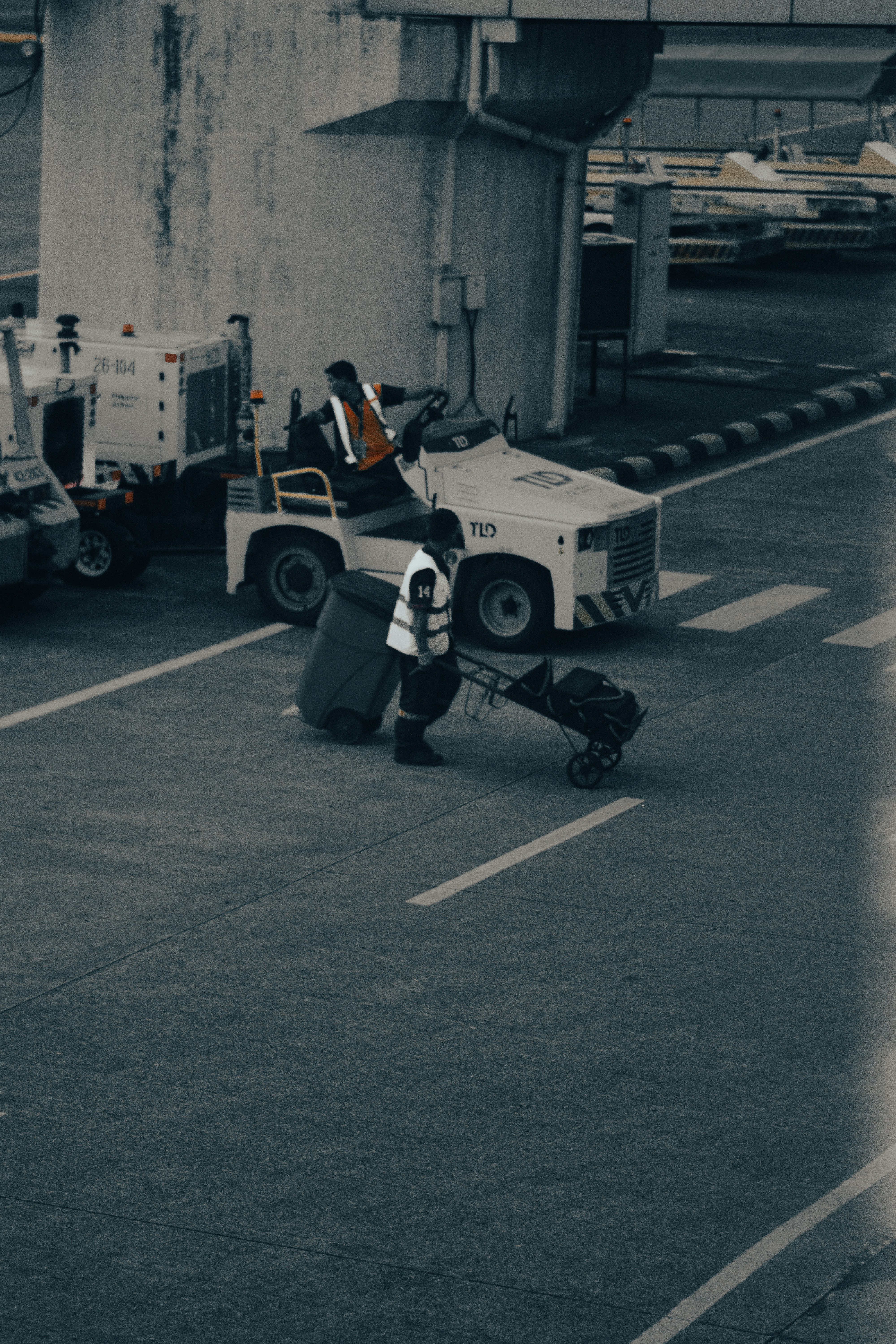A man pushing a cart with luggage on it