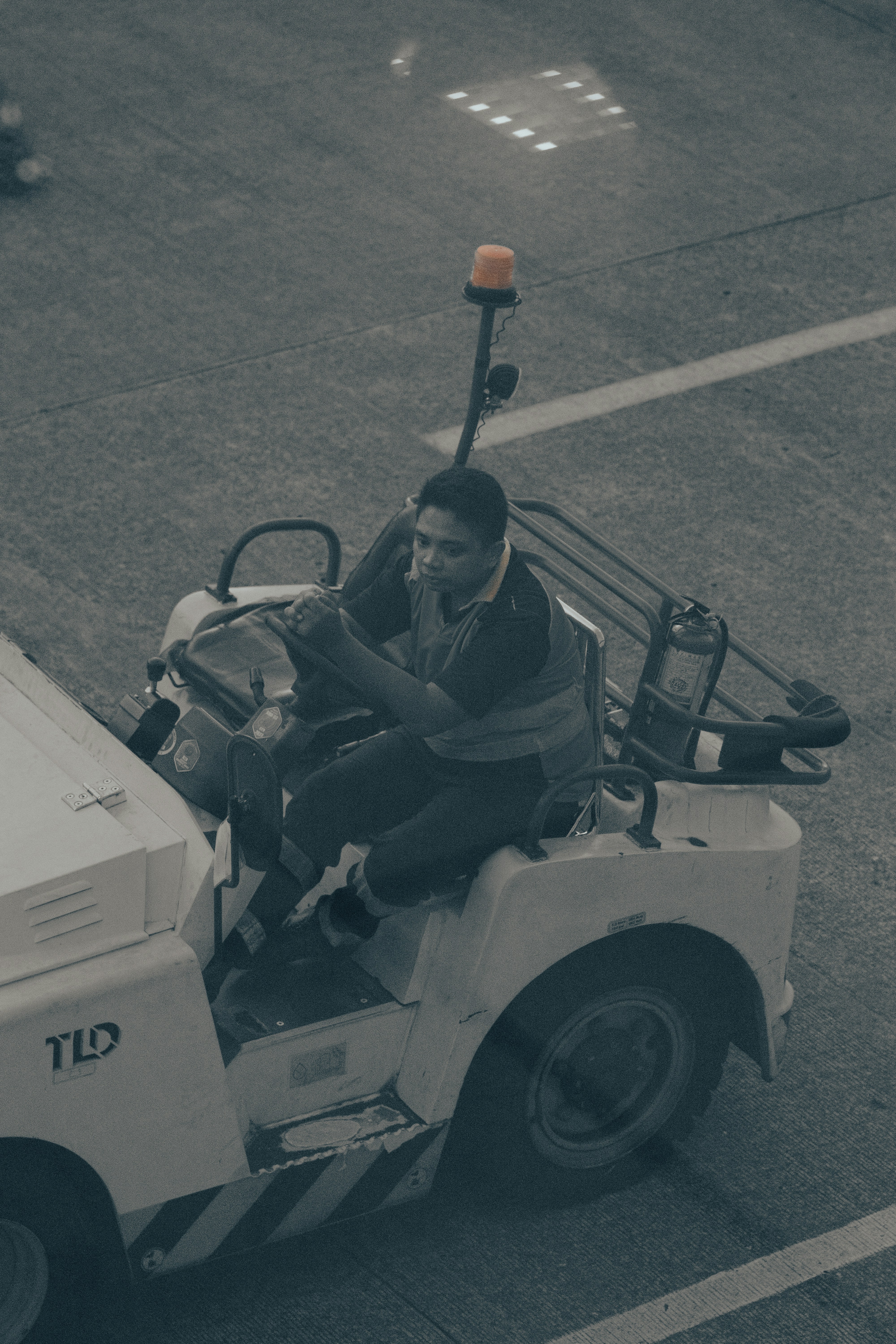 A man riding on the back of a white utility vehicle