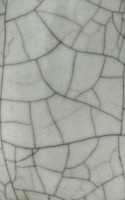Cracked white ceramic surface with fine black lines.