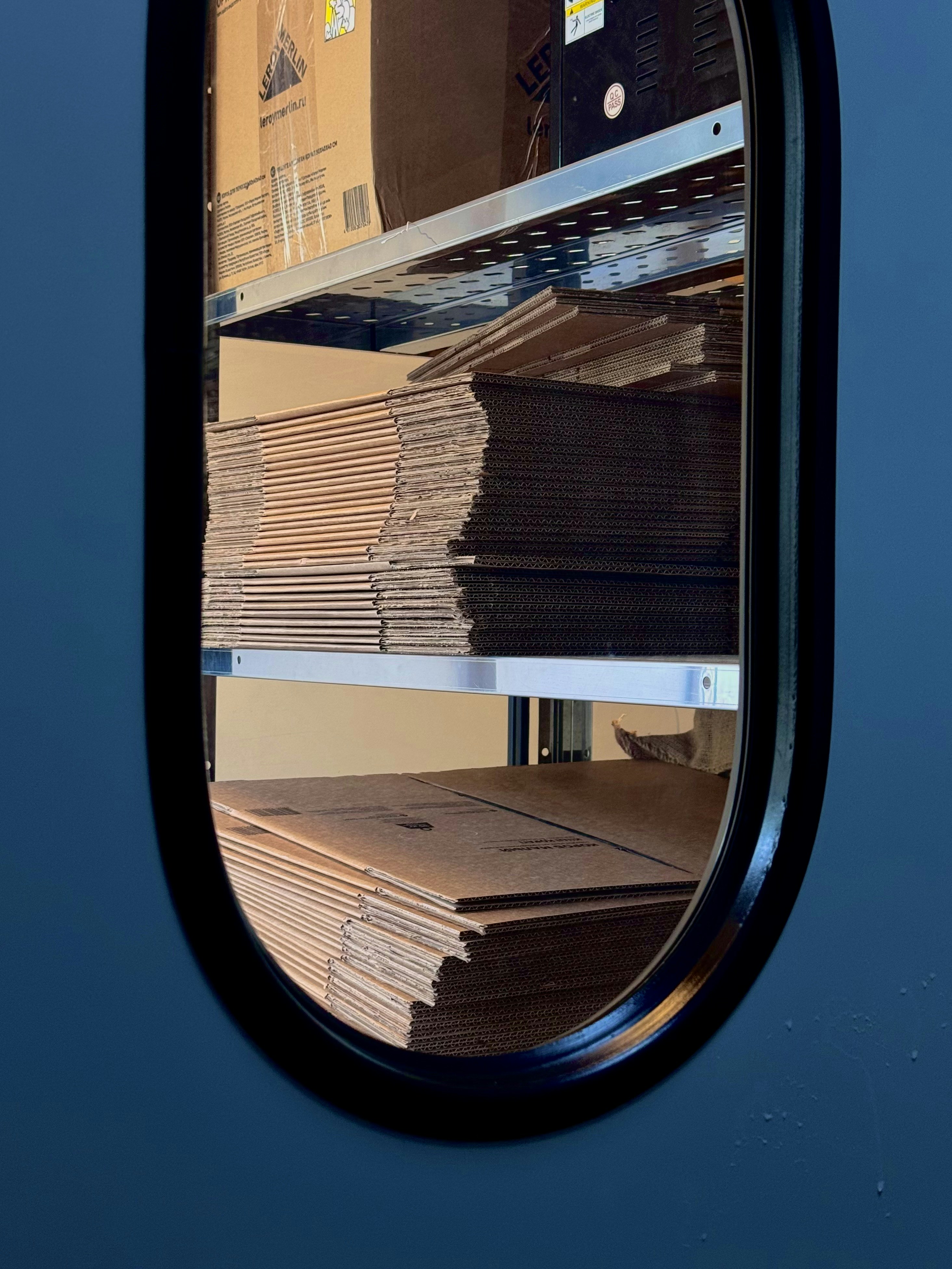 A stack of boxes sitting on top of a shelf