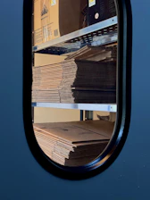 A stack of boxes sitting on top of a shelf